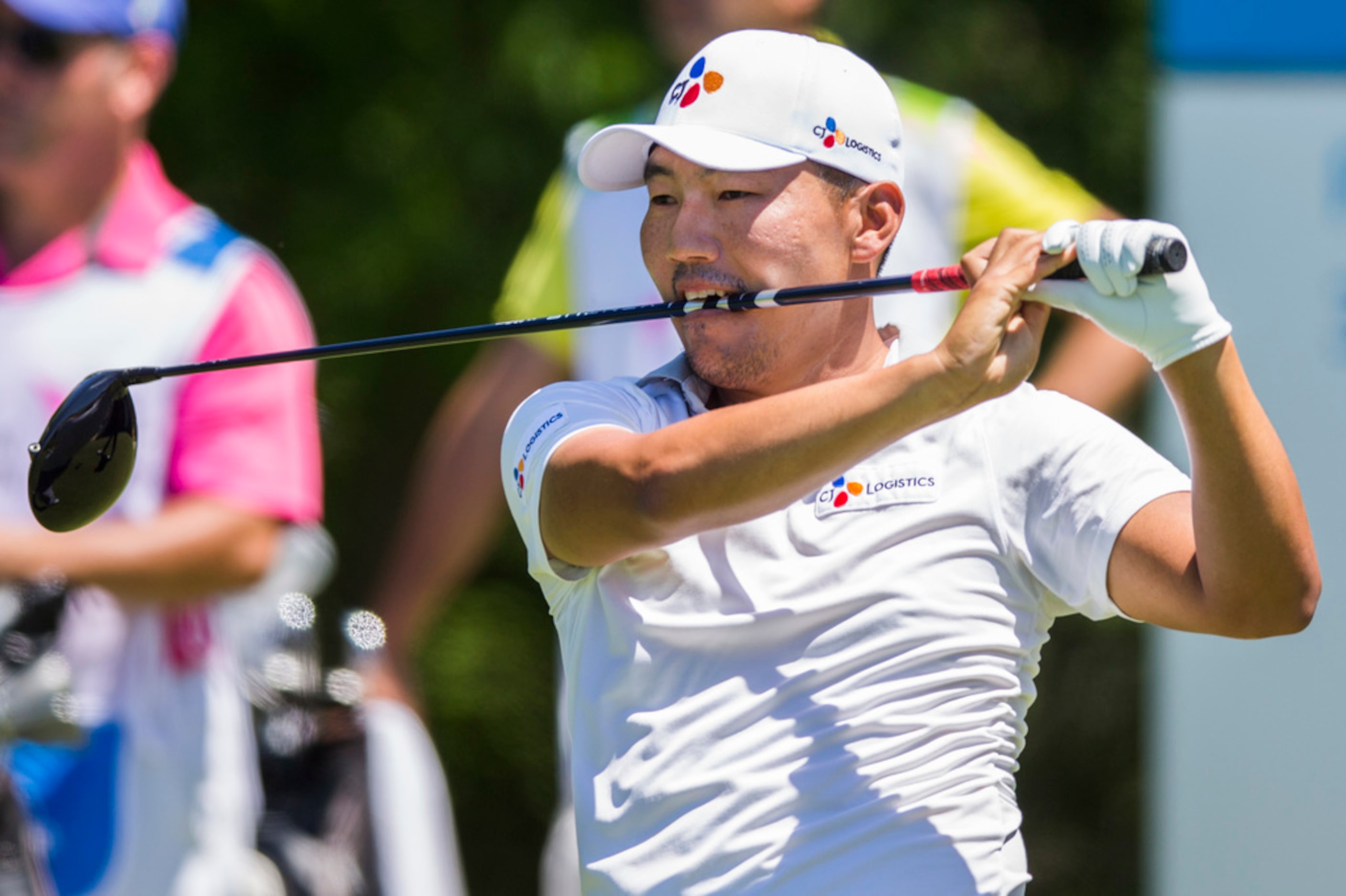 Sung Kang bites his driver in response to his tee shot on hole 5 during round 4 of the AT&T...