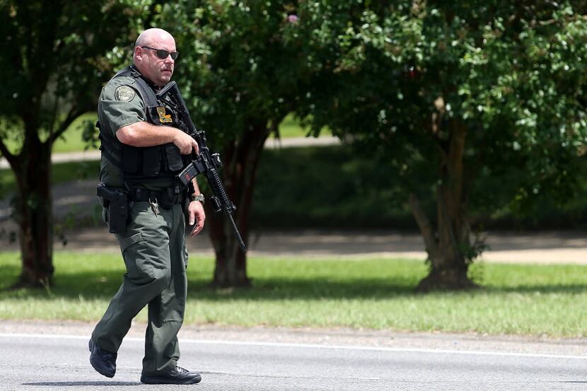  Baton Rouge police officers patrol Airline Hwy after at least three police officers were...