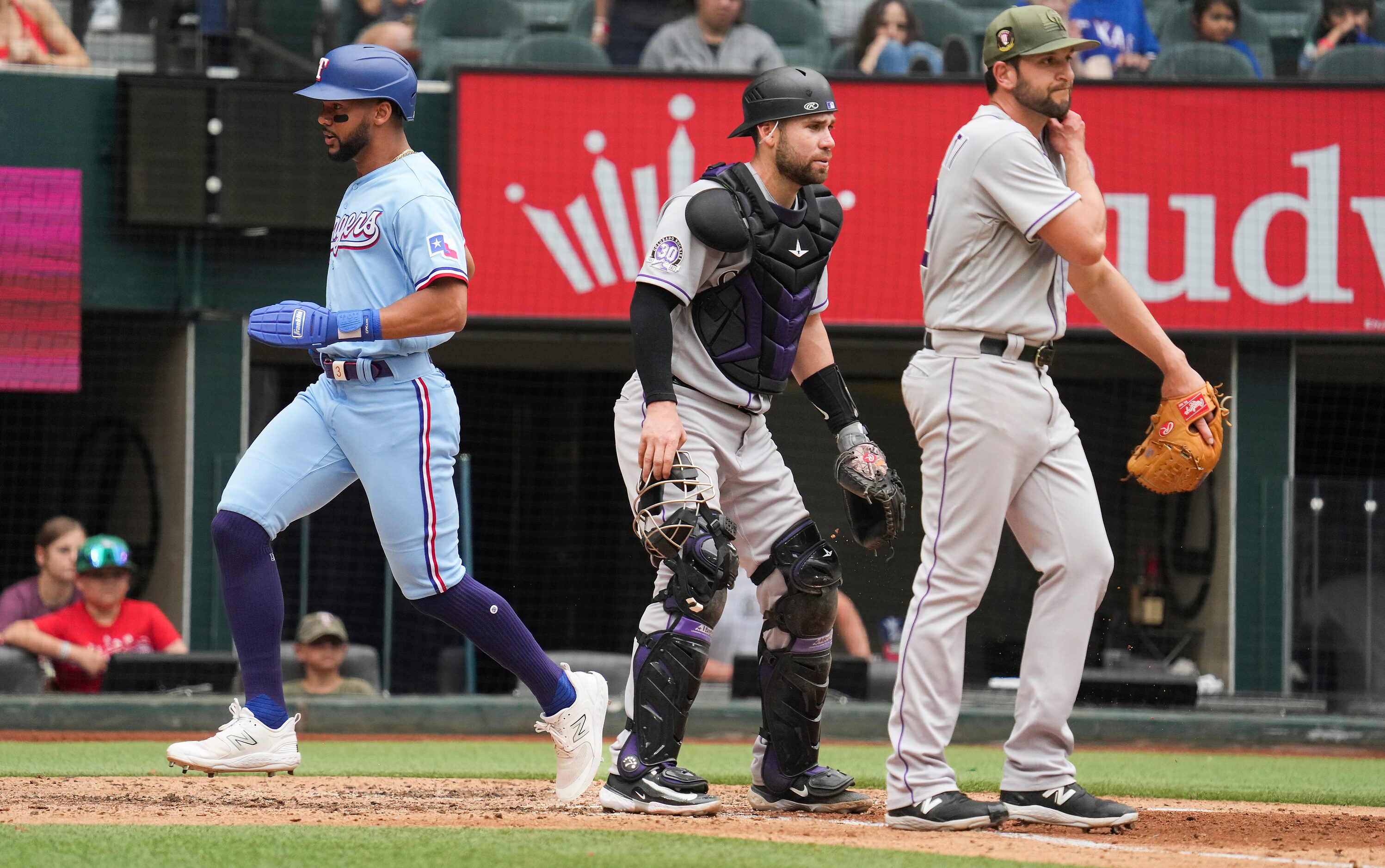 Texas Rangers center fielder Leody Taveras scores past Colorado Rockies catcher Austin Wynns...