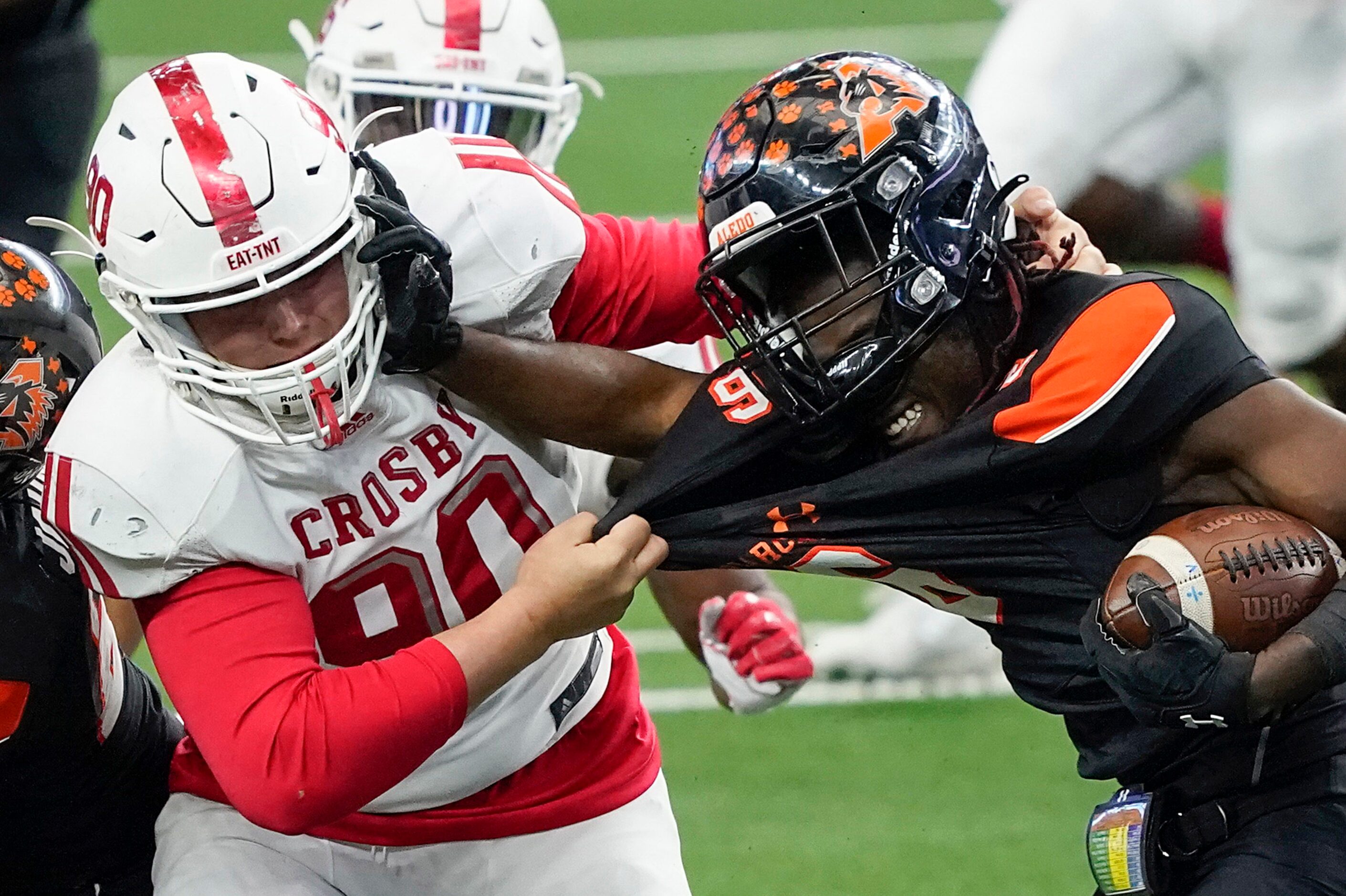 Aledo running back DeMarco Roberts (6) fights for yardage against Crosby defensive lineman...