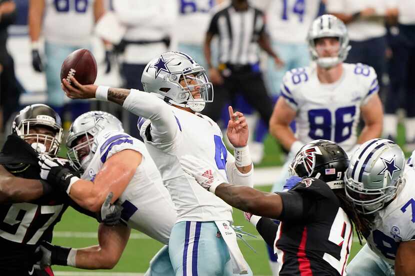 Dallas Cowboys quarterback Dak Prescott throws a pass under pressure from the Atlanta...