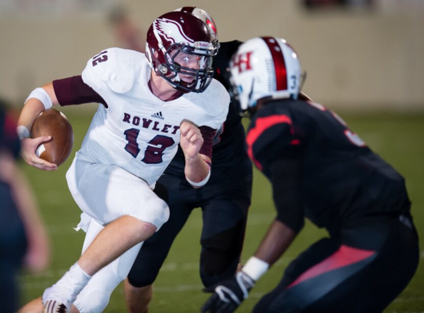 Rowlett sophomore quarterback Logan Bonner dodges several Lake Highlands players during last...