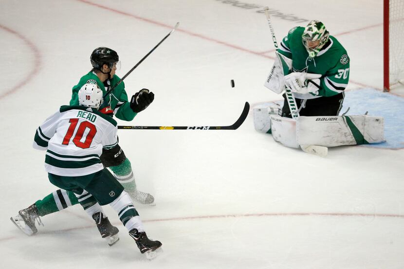 Dallas Stars goaltender Ben Bishop (30) blocks a third period shot from Minnesota Wild right...