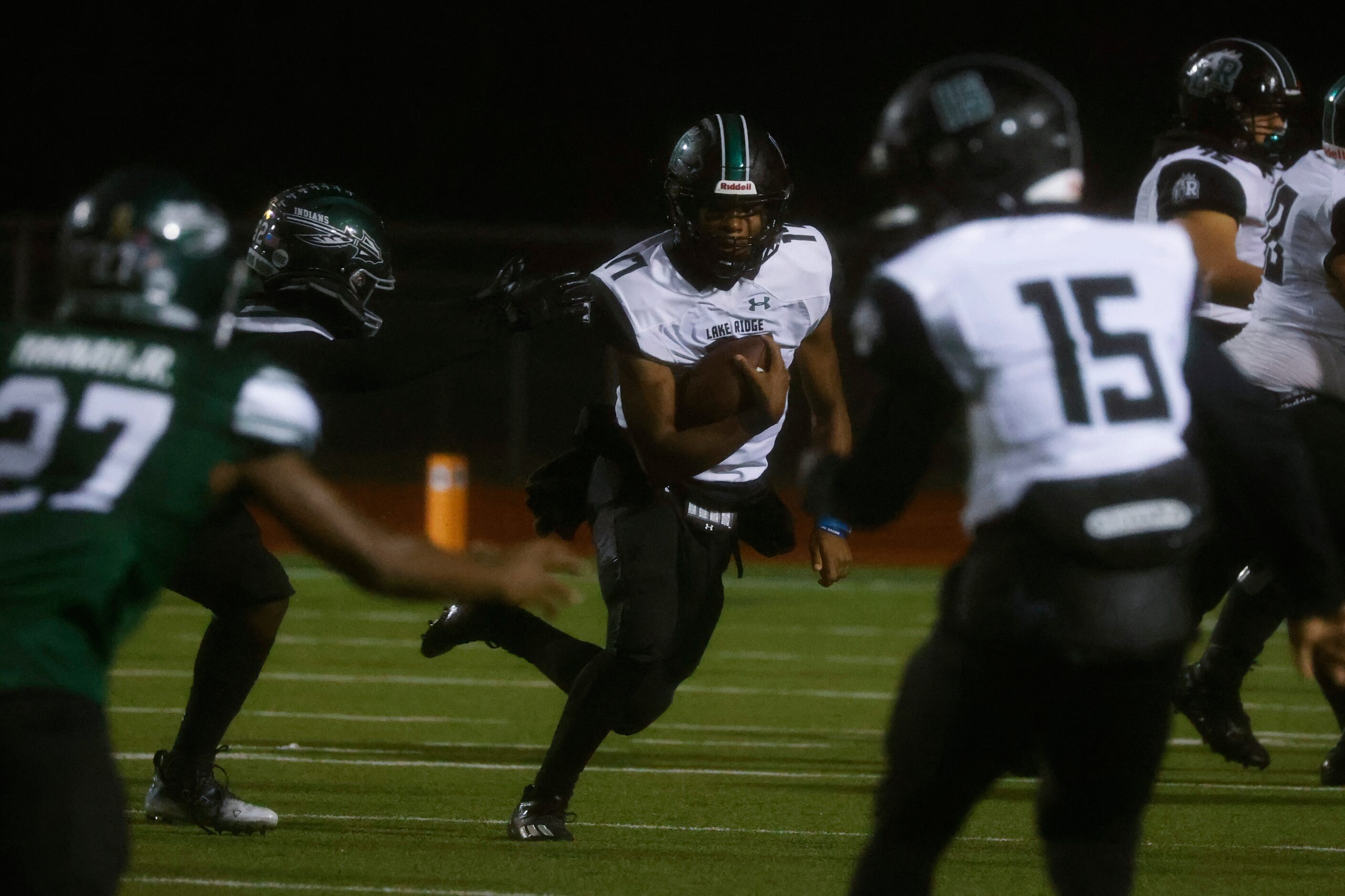 Mansfield Lake Ridge High School’s QB Kennen Miller (17) looks to pass against  Waxahachie...