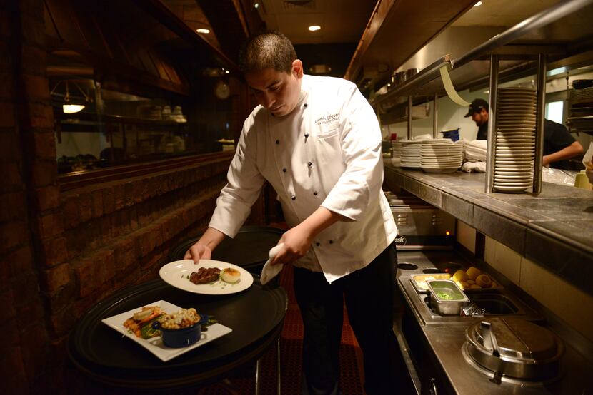 Executive Chef Valentin Echeverria, 28, serves up an order of food at Chamberlain's Fish...