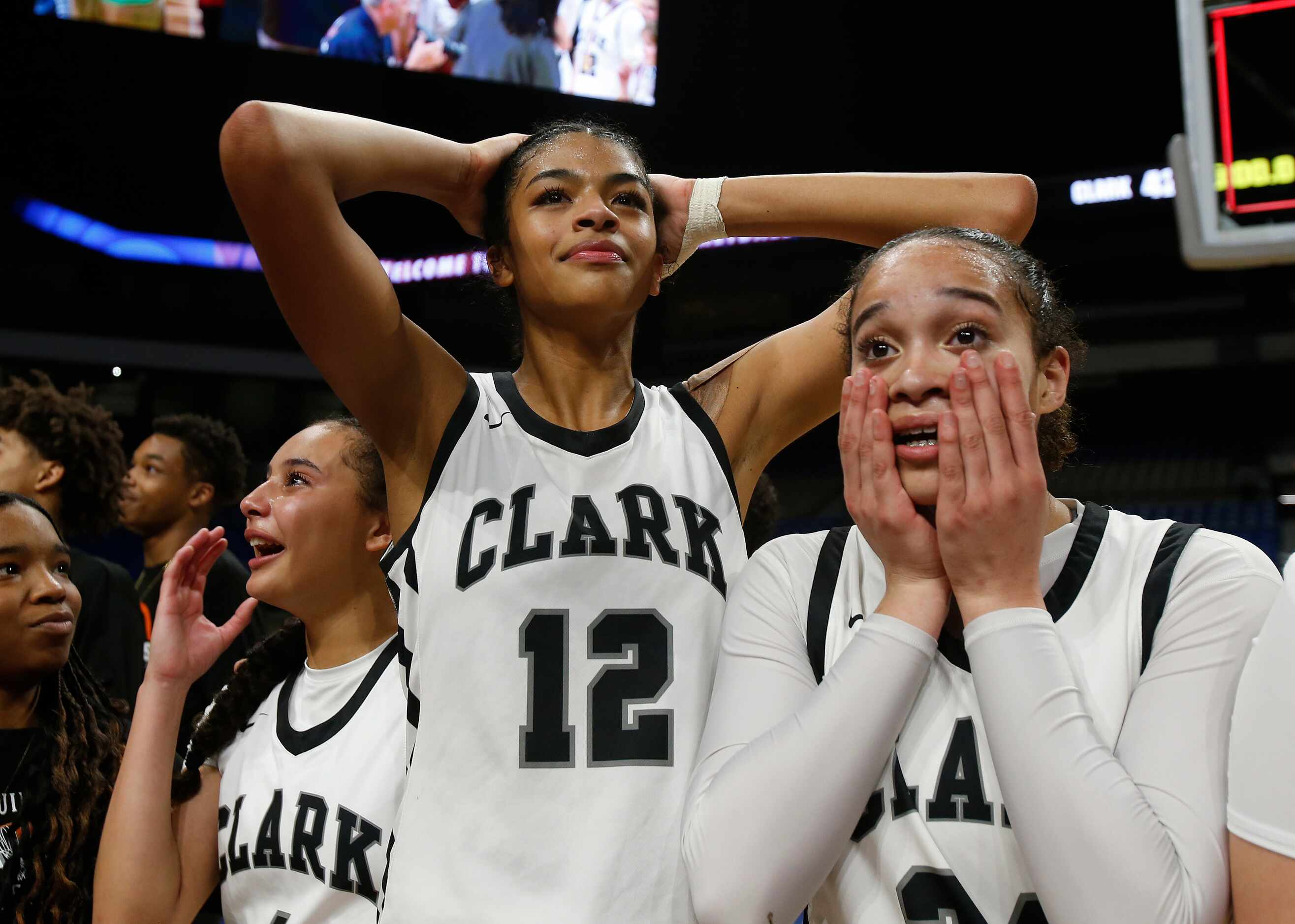 Clark Cougars’ Natalie Huff (1), Adrianna Roberson (12) and Kamryn Griffin (24) react after...