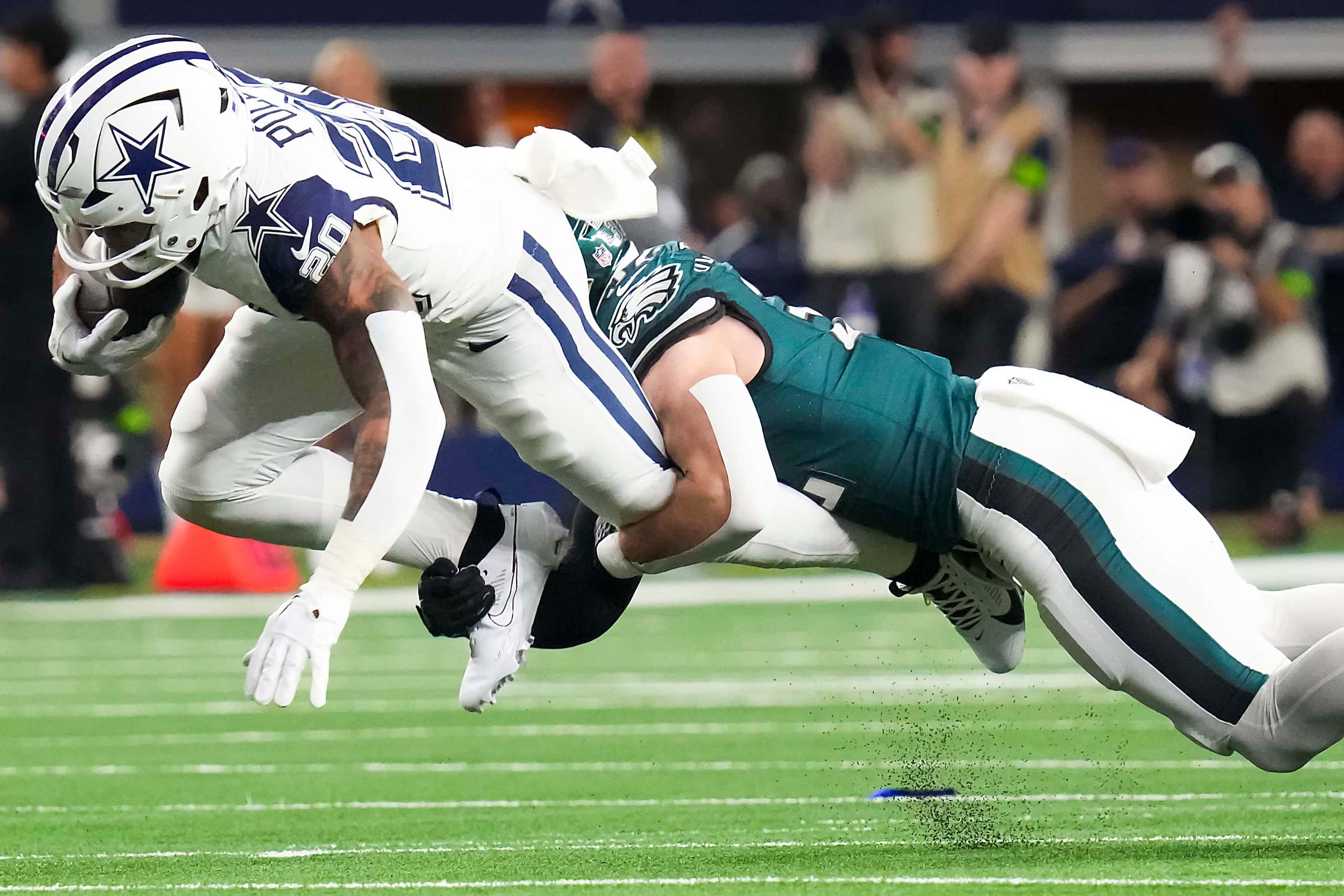 Dallas Cowboys running back Tony Pollard (20) is brought down by Philadelphia Eagles safety...