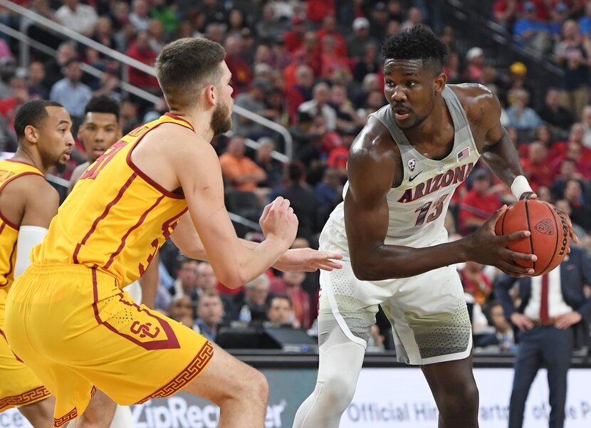 LAS VEGAS, NV - MARCH 10:  Nick Rakocevic #31 of the USC Trojans guards Deandre Ayton #13 of...