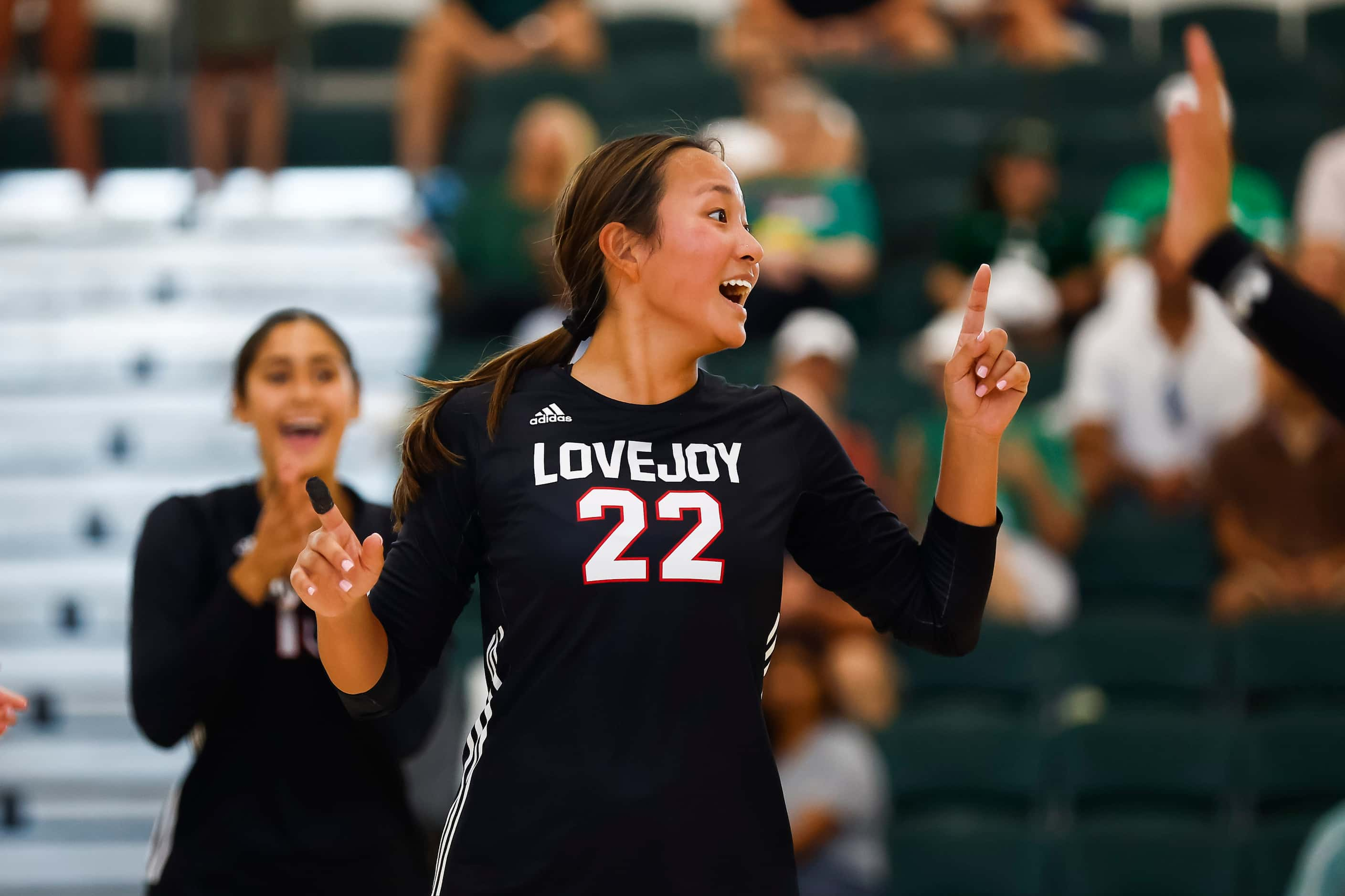 Love Joy senior setter Bethanie Wu celebrates a point during a high school volleyball match...