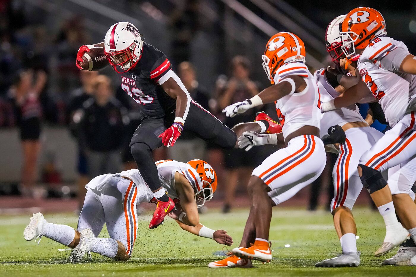 Rockwall-Heath running back  Zach Evans (26) hurdles a Rockwall defender during the first...