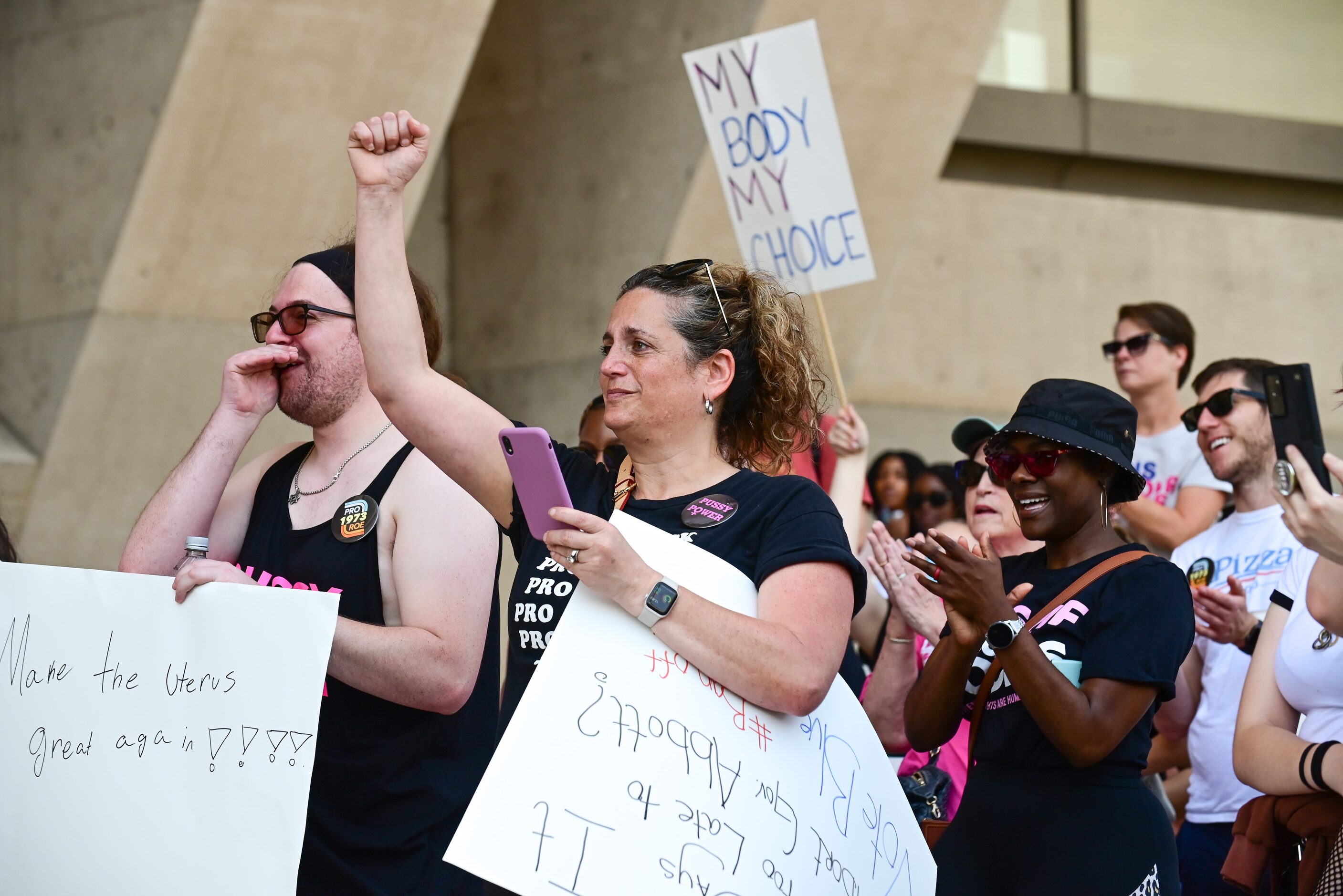 Stacy Greenberg, 48, of Arlington, shakes her fist while cheering for abortion rights during...