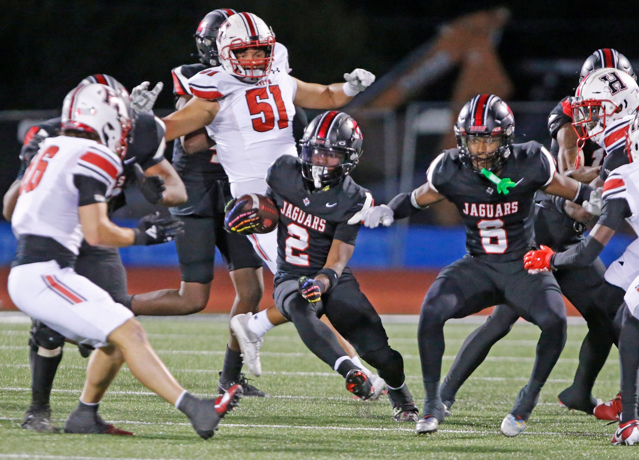 Mesquite Horn’s Levon Morton (2) weaves through the Rockwall Heath defense for a first down...