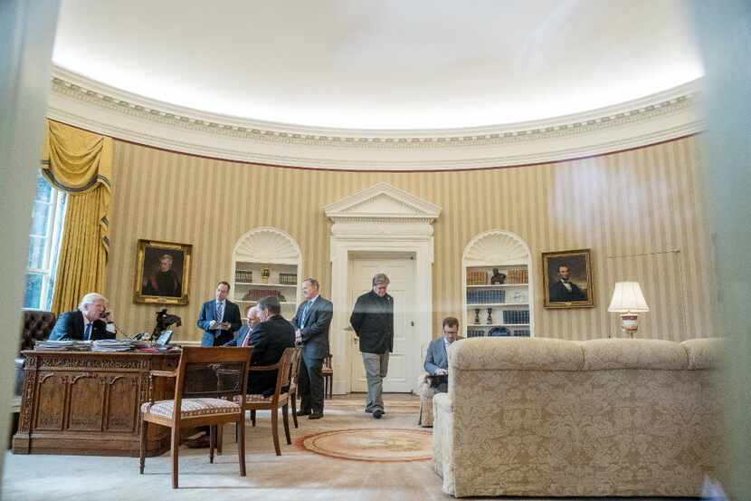 President Donald Trump, left, accompanied by from left, Chief of Staff Reince Priebus, Vice...
