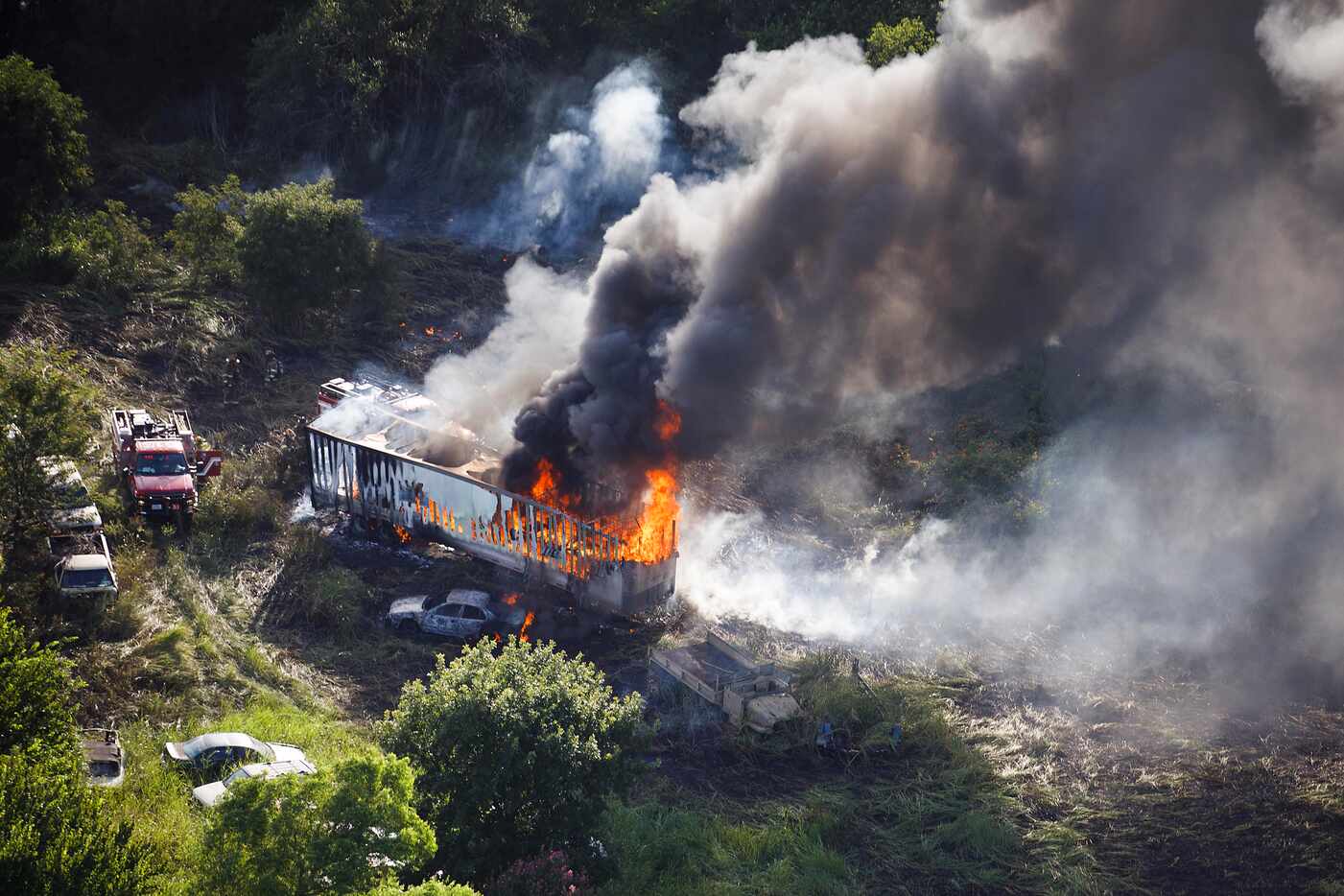 Dallas Fire Rescue units battle a tire fire at a drag strip near Grand Prairie on Thursday,...