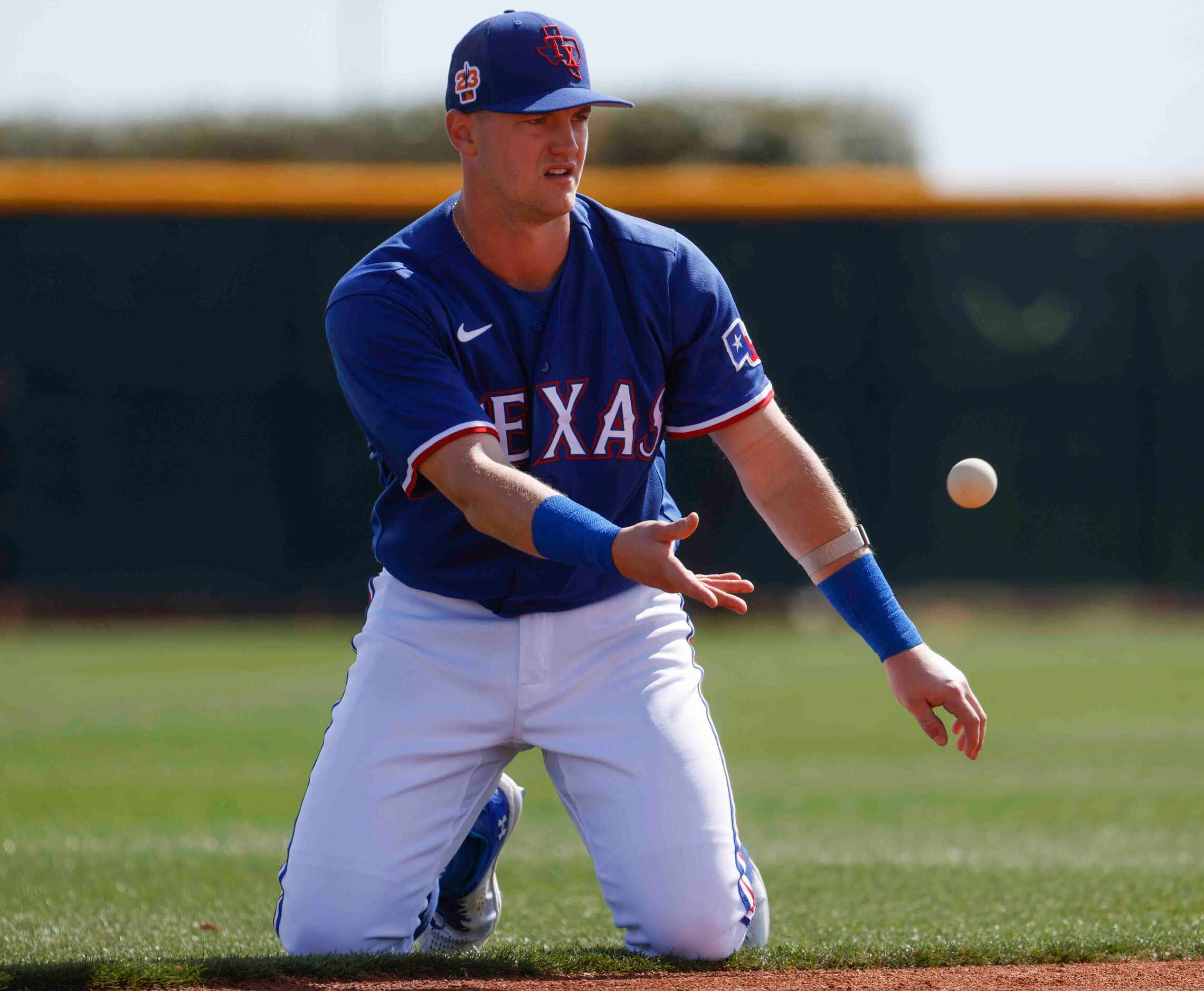 Texas Rangers infielder Josh Jung goes through a drill during a spring training workout at...