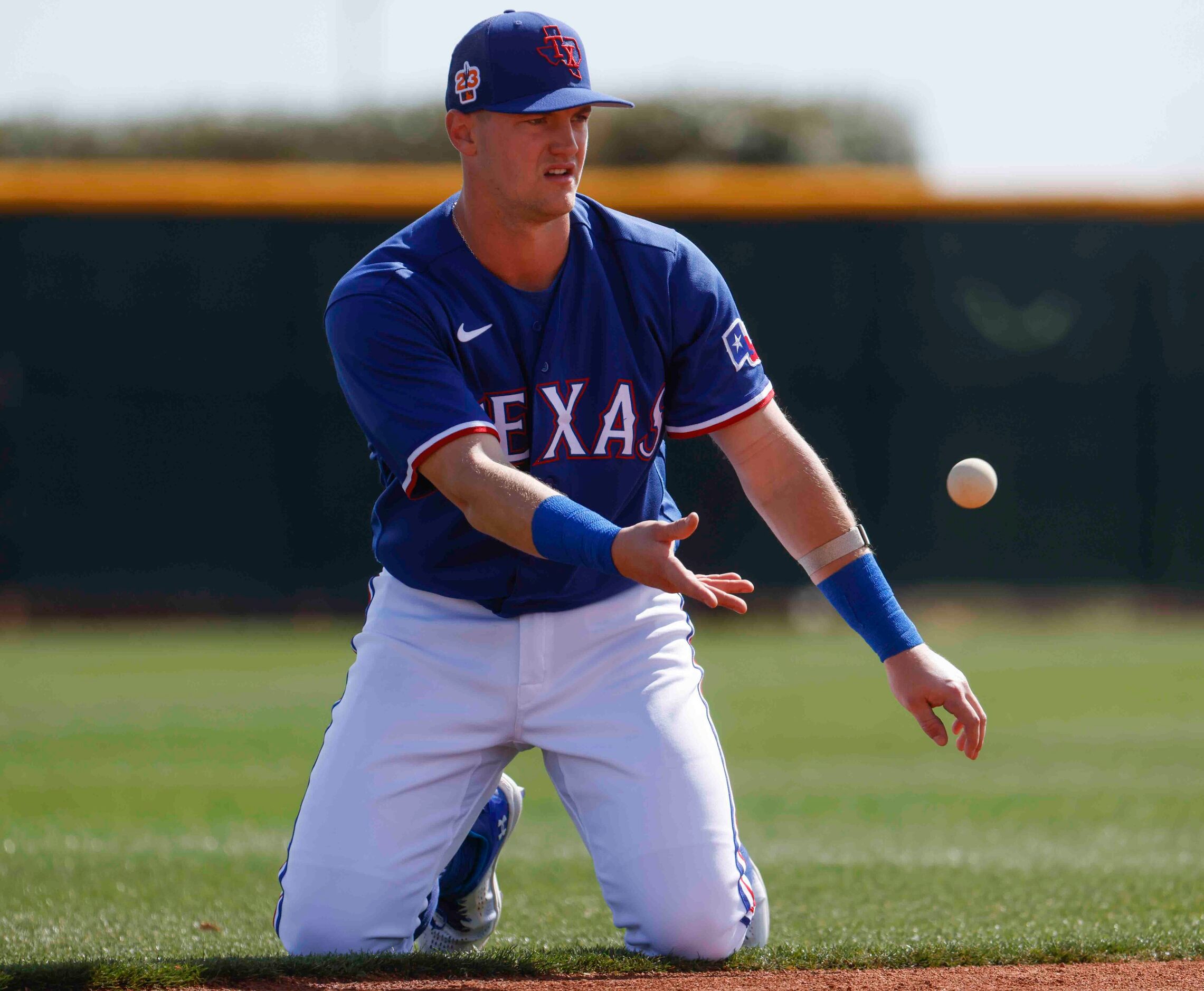 Texas Rangers infielder Josh Jung goes through a drill during a spring training workout at...