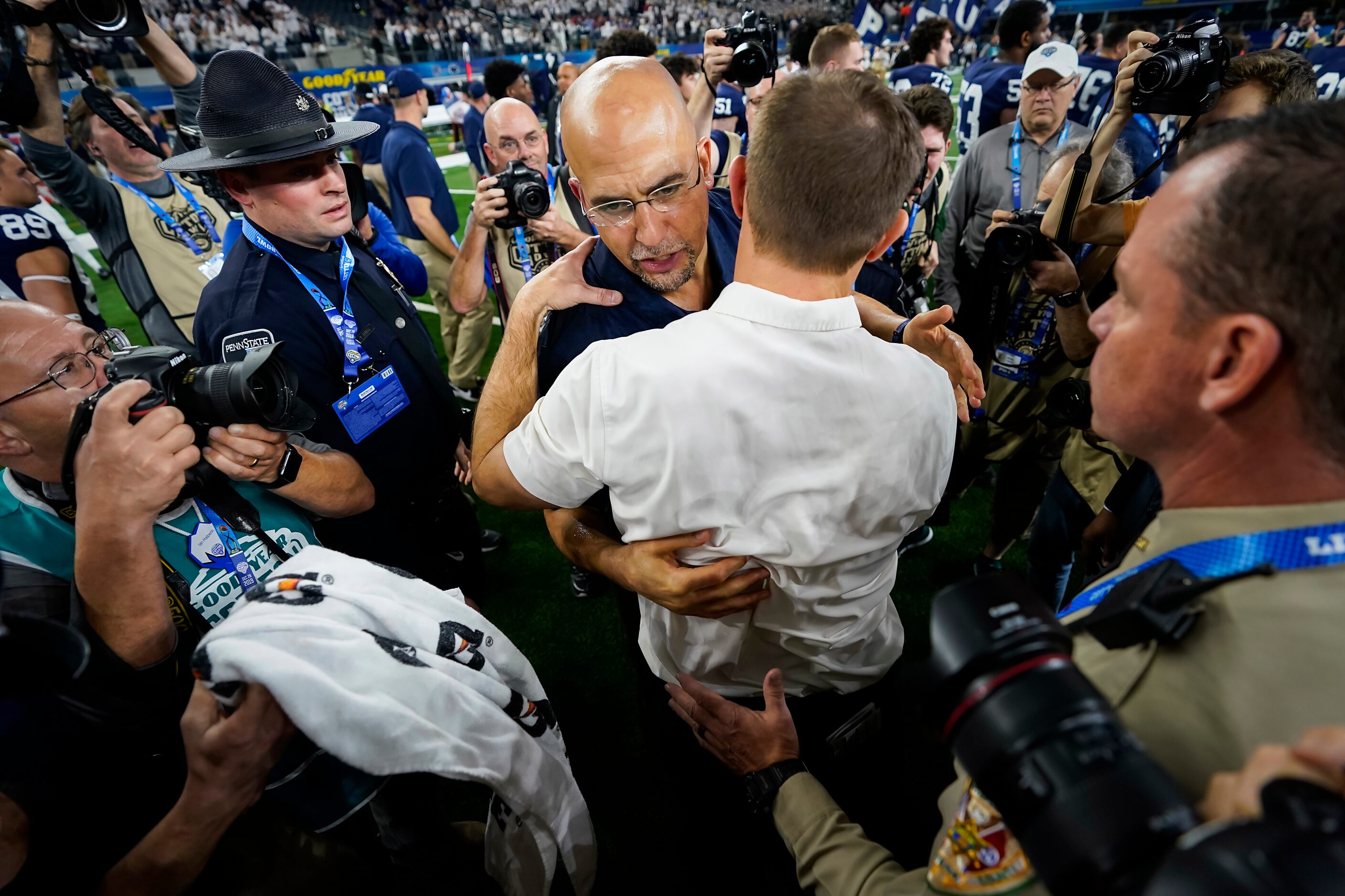 Penn State head coach James Franklin hugs Memphis head coach Ryan Silverfield after the...