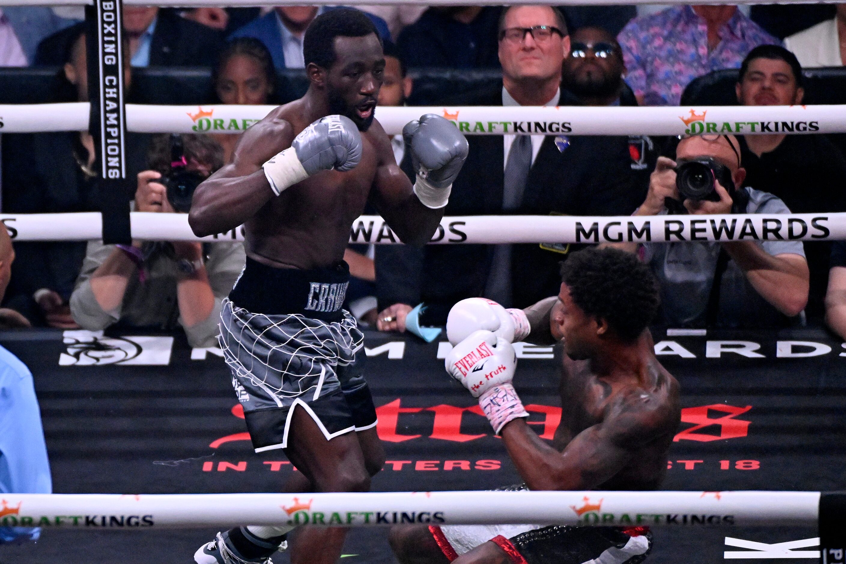 Terence Crawford, left, knocks down Errol Spence Jr. fight during their undisputed...