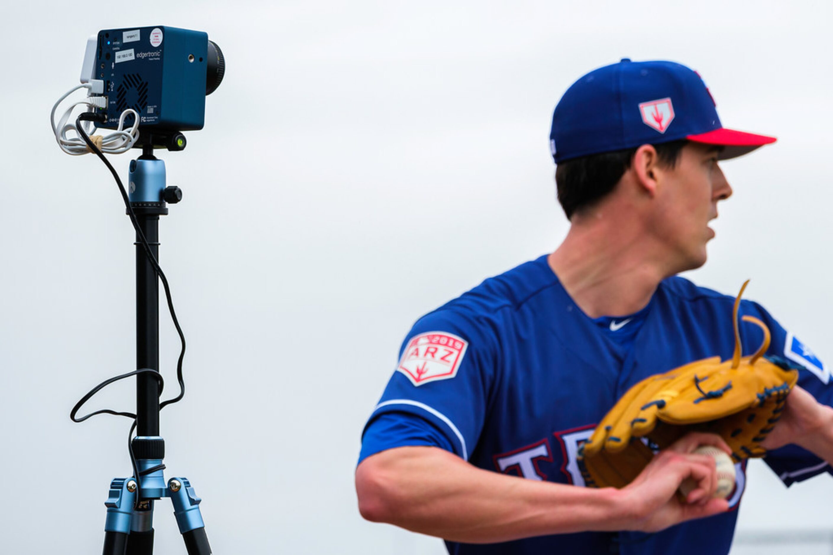 Texas Rangers pitcher Luke Farrell throws in the bullpen with a edgertronic high speed...