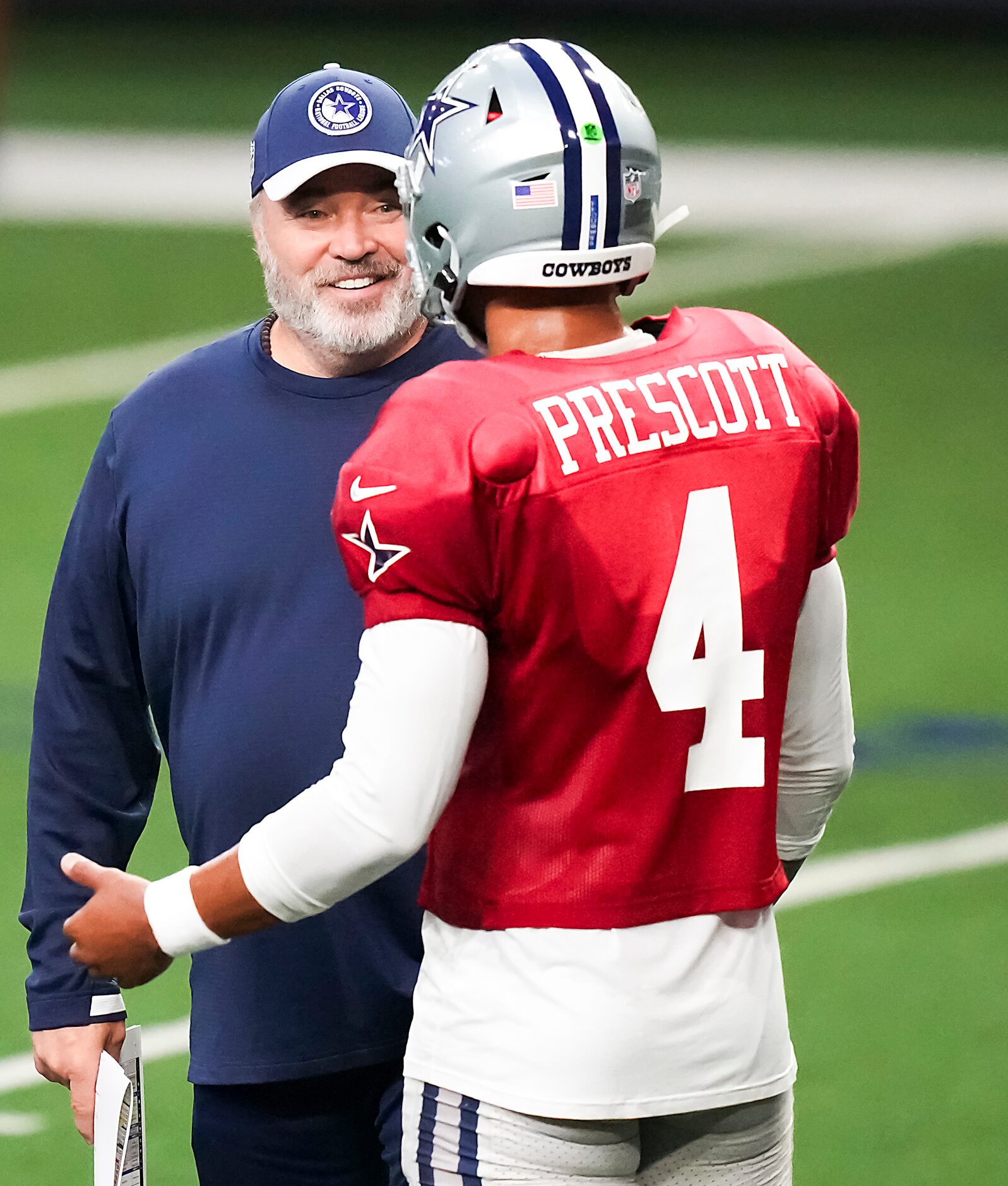 Dallas Cowboys head coach Mike McCarthy talks with quarterback Dak Prescott (4) during the...