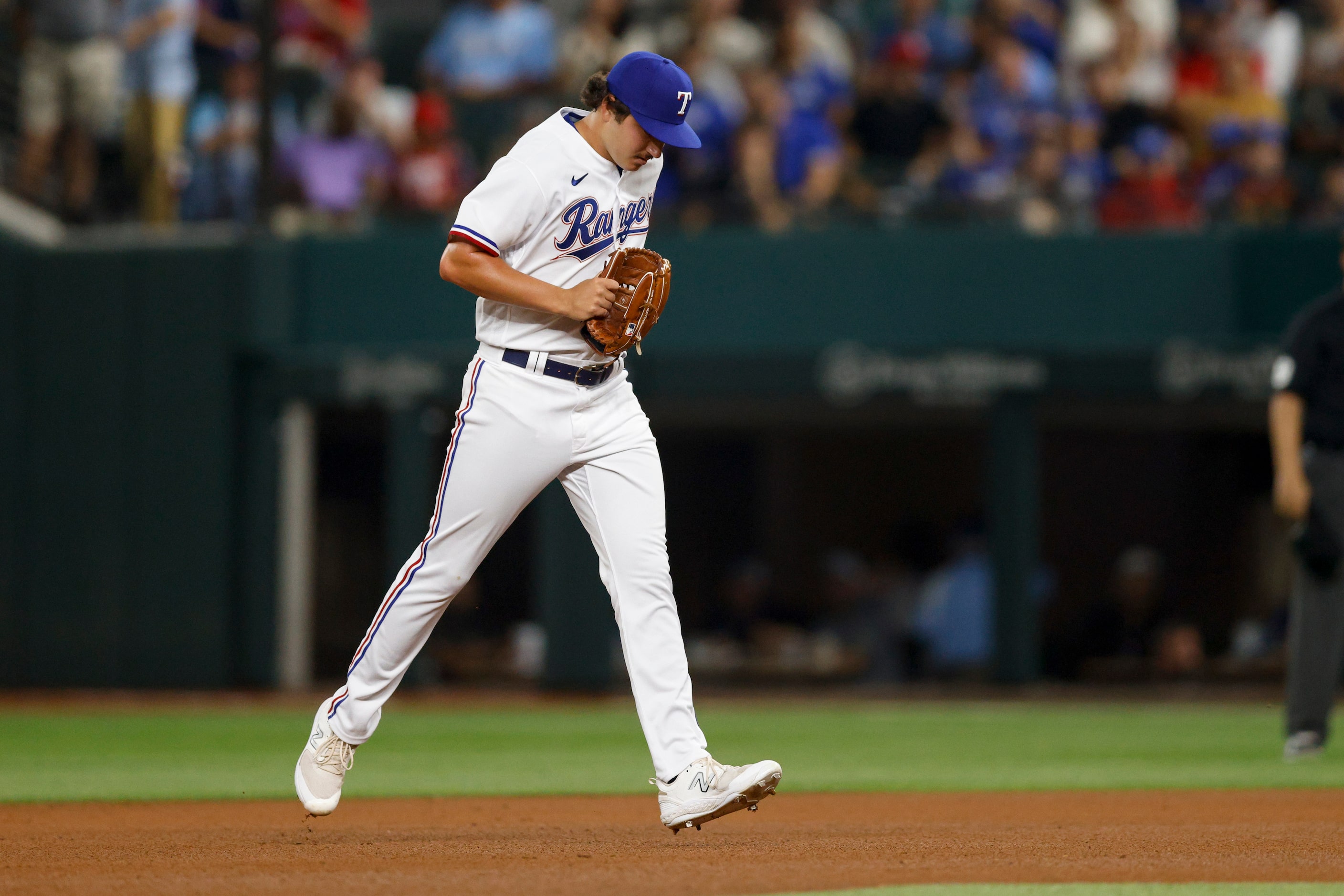 Texas Rangers relief pitcher Owen White (43) jogs to the mound as he makes his major league...