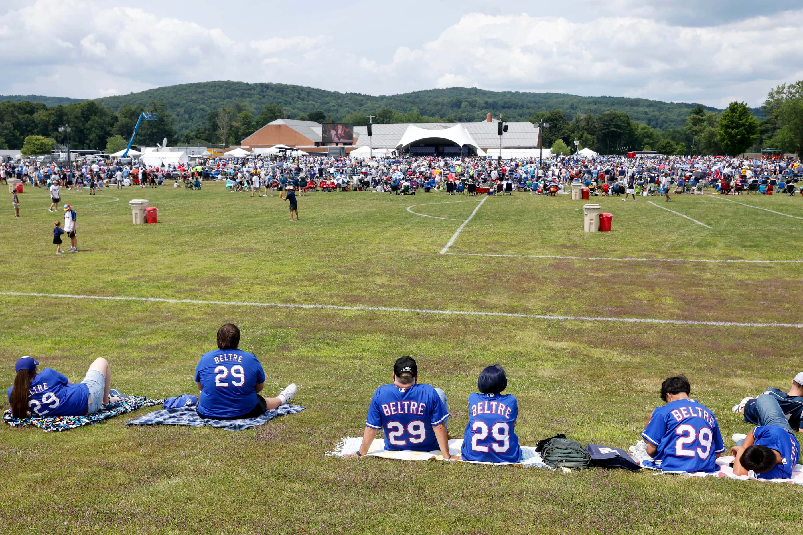 Fans of former Texas Rangers third baseman Adrián Beltré sit on a hill overlooking thousands...