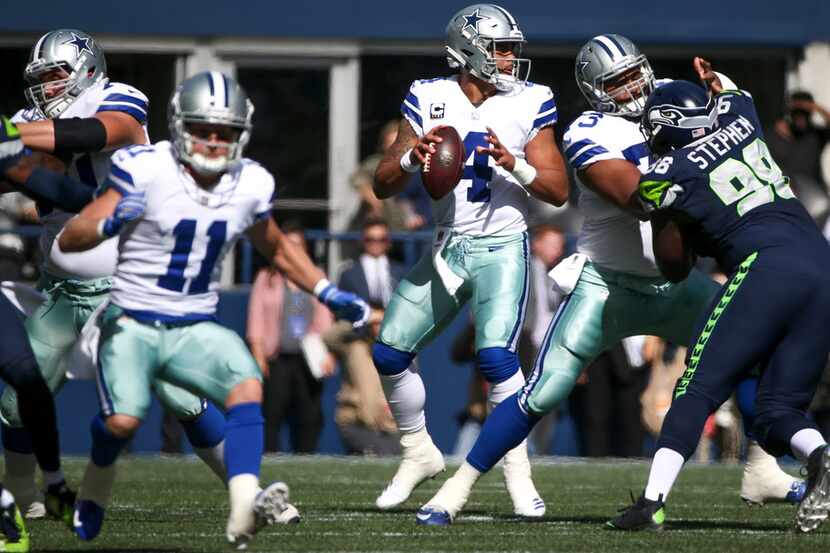 Dallas Cowboys quarterback Dak Prescott (4) looks to make a pass during the first quarter of...