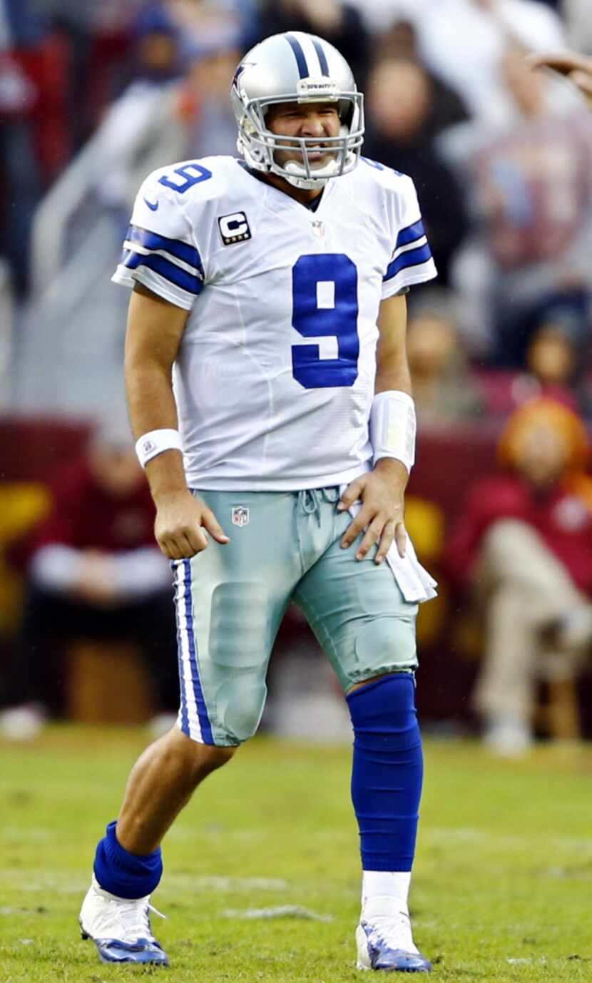 Dallas Cowboys quarterback Tony Romo grimaces after a play during the second half of Dallas'...