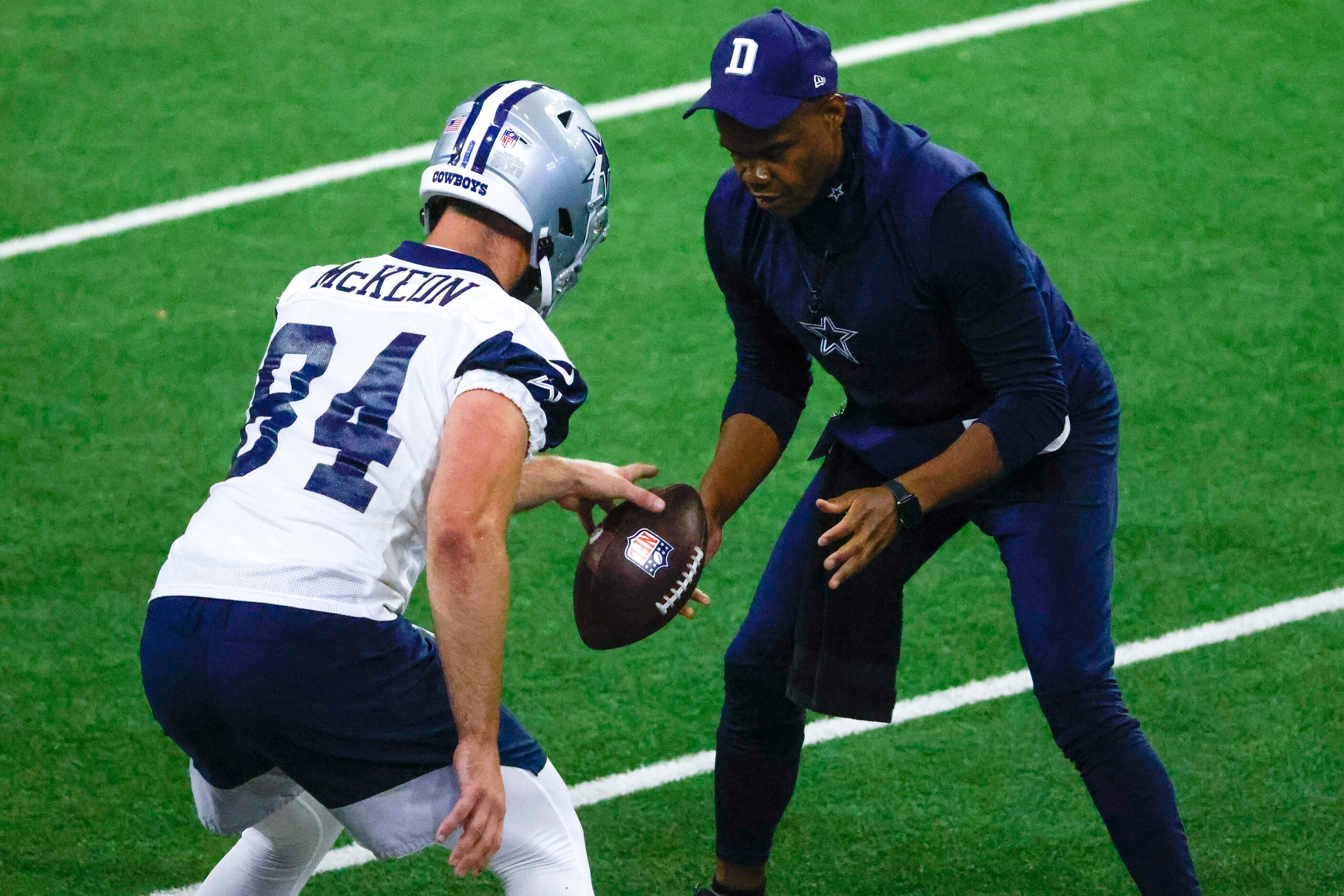 Dallas Cowboys tight end Sean McKeon (84) and  tight ends coach Lunda Wells takes part in a...