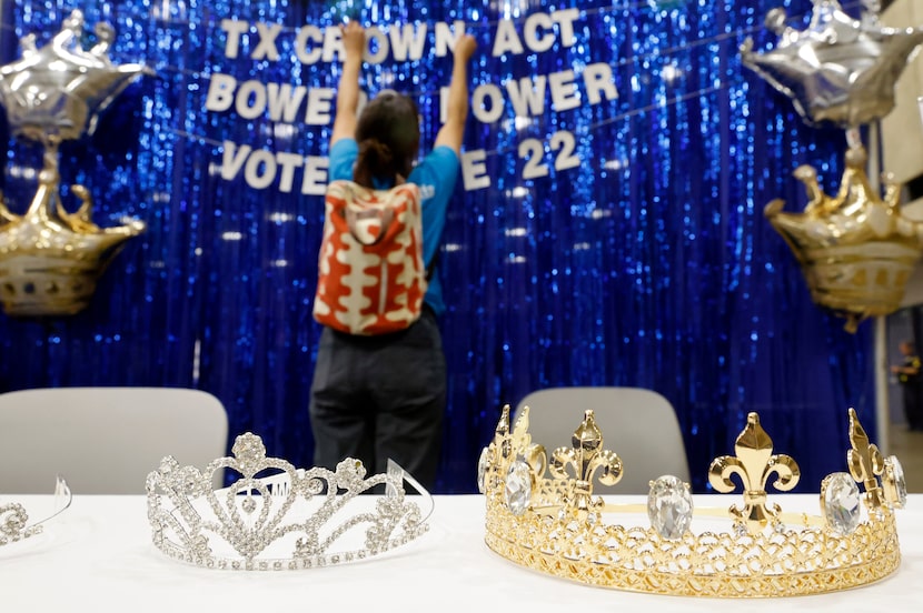 Maria Cornell adjusts the lettering in Rhetta Andrews Bowers booth during the opening day of...