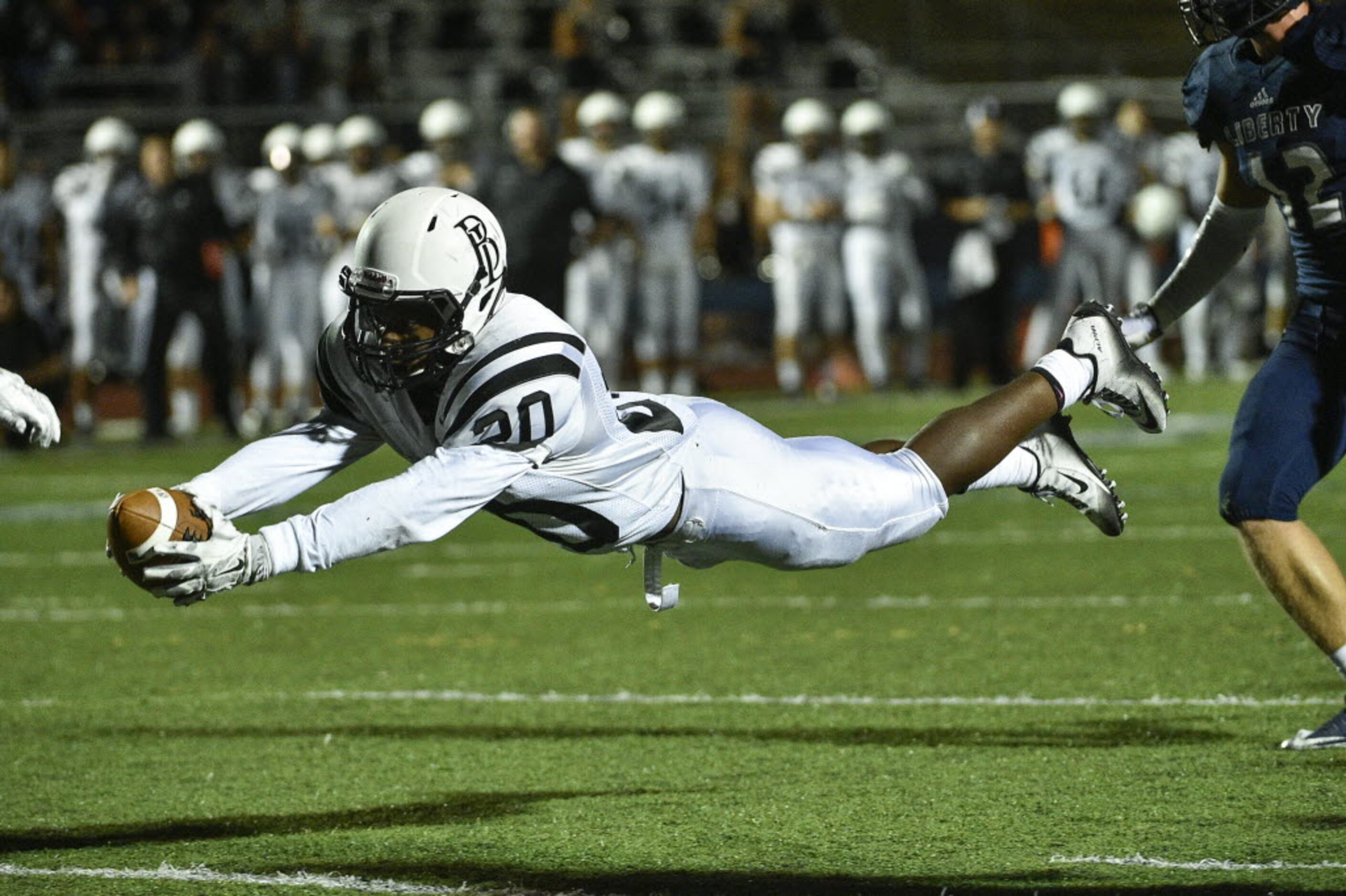 Bishop Lynch running back Jermaine Mask (20) dives across the goal line during a high school...