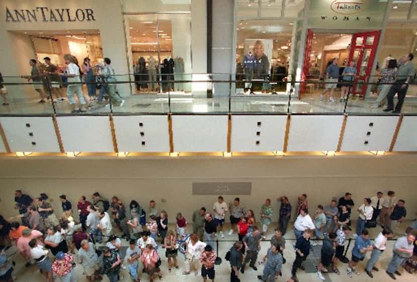 A line of shoppers waited to get into the first Apple store in Texas in Plano's Shops at...