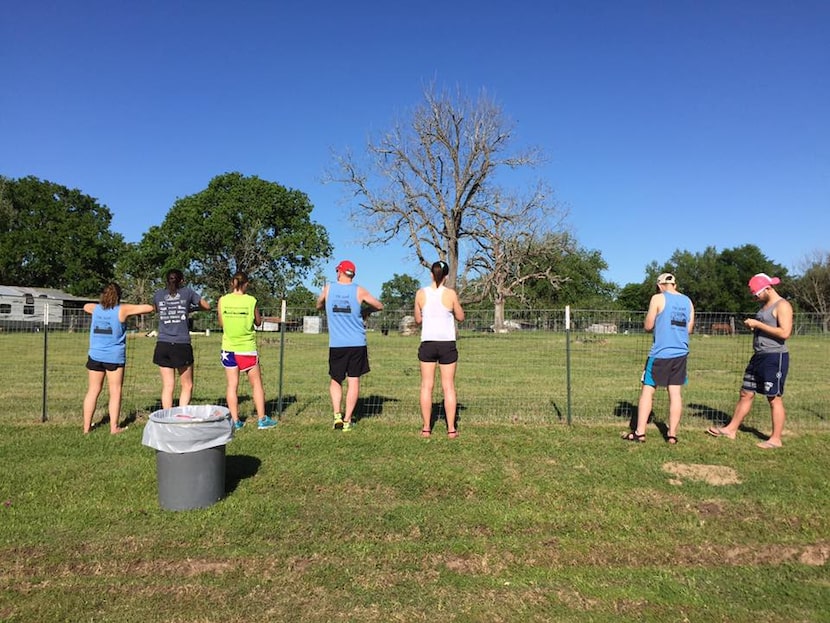 The DallAss Kickers stand outside the Leihardt family's fence in Schulenberg, watching...