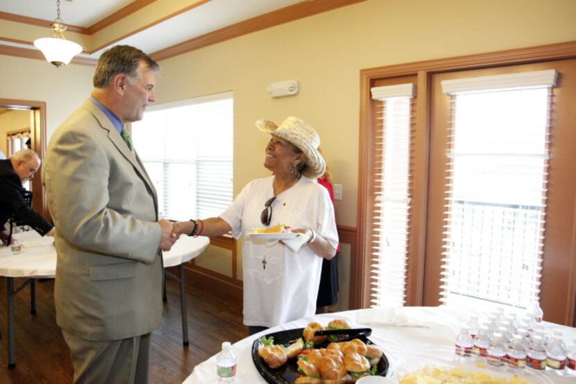 Dallas Mayor Mike Rawlings greeted future resident Rebecca Martinez after a ribbon-cutting...