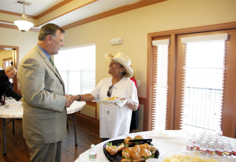 Dallas Mayor Mike Rawlings greeted future resident Rebecca Martinez after a ribbon-cutting...