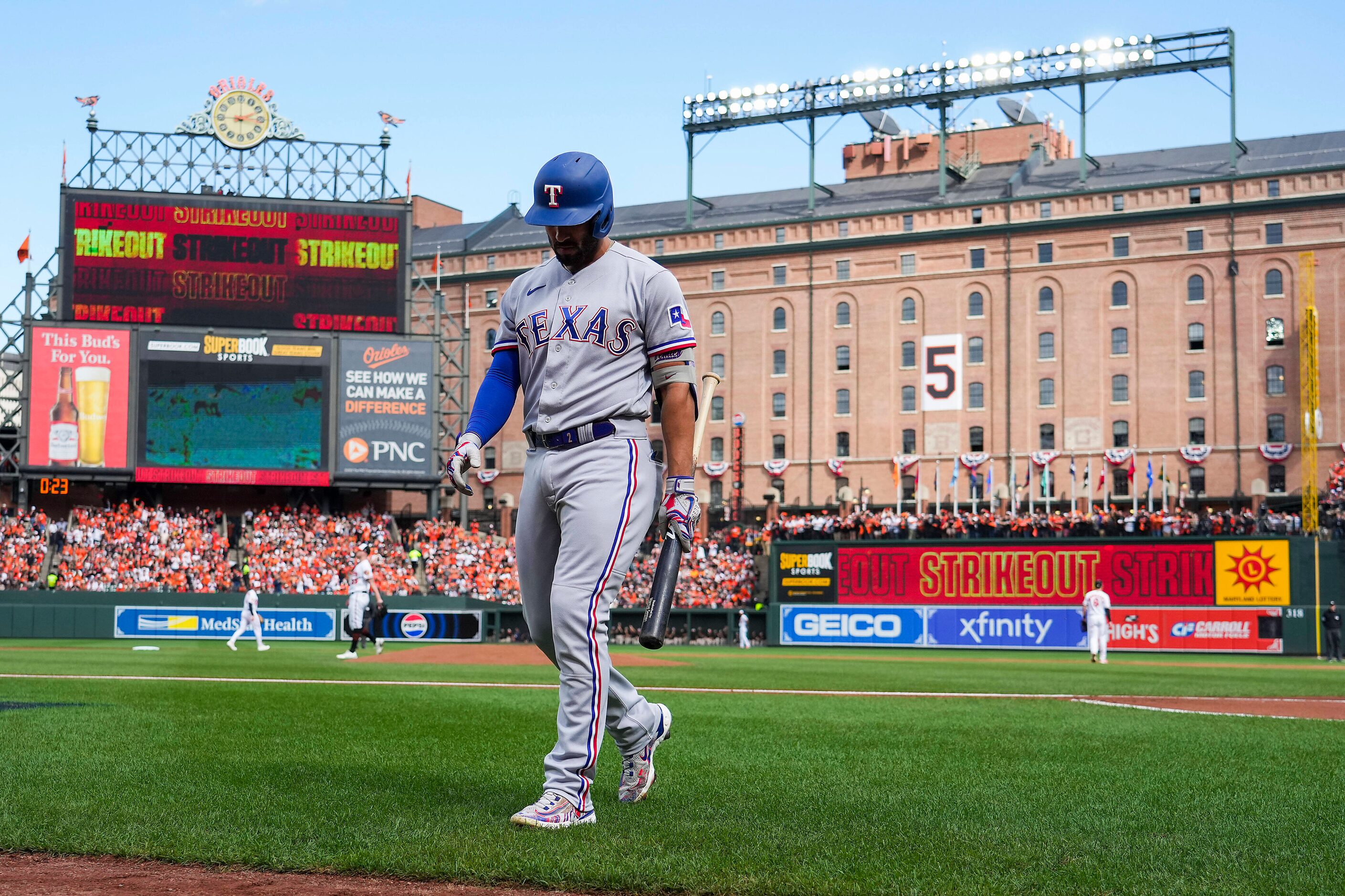 Texas Rangers right fielder Adolis Garcia (53) heads back to the dugout after striking out...