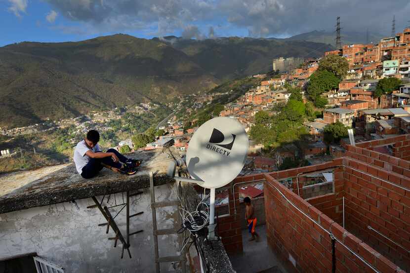 A DirectTV dish stands on home in the Catia neighborhood of Caracas, Venezuela, Thursday,...
