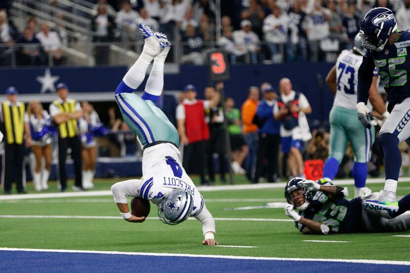 Dallas Cowboys quarterback Dak Prescott (4) dives for more yards but is stopped by Seattle...