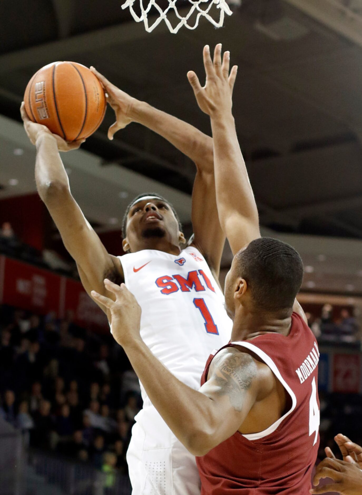 SMU forward Feron Hunt (1) drives the lane and pits up a shot against the defense of Temple...