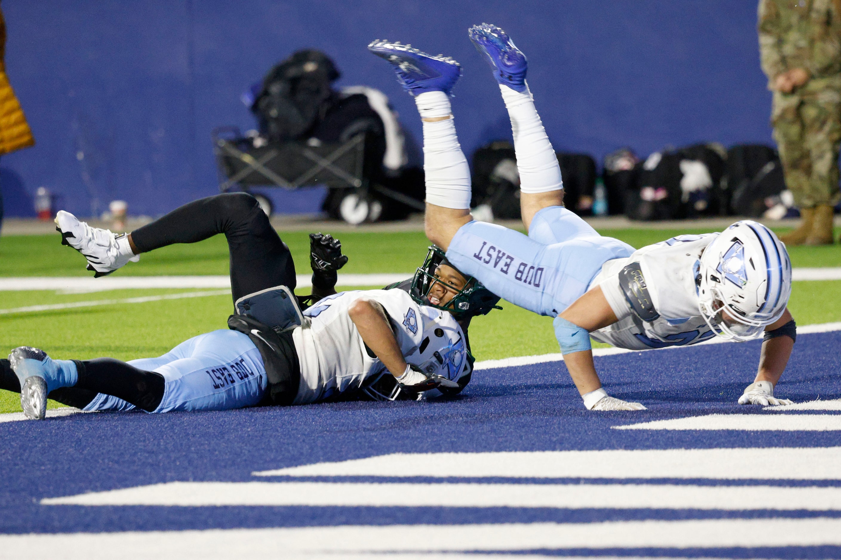 DeSoto's Ethan Feaster (7), behind, scores a touchdown over Wylie East's Damon Vinson (12),...