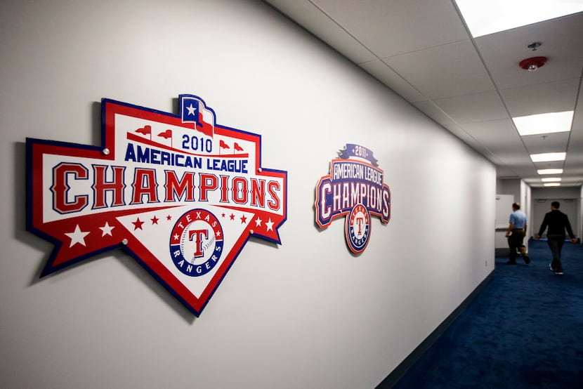 Reminders of the team's 2010 and 2011 American League championships hang in a hallway...