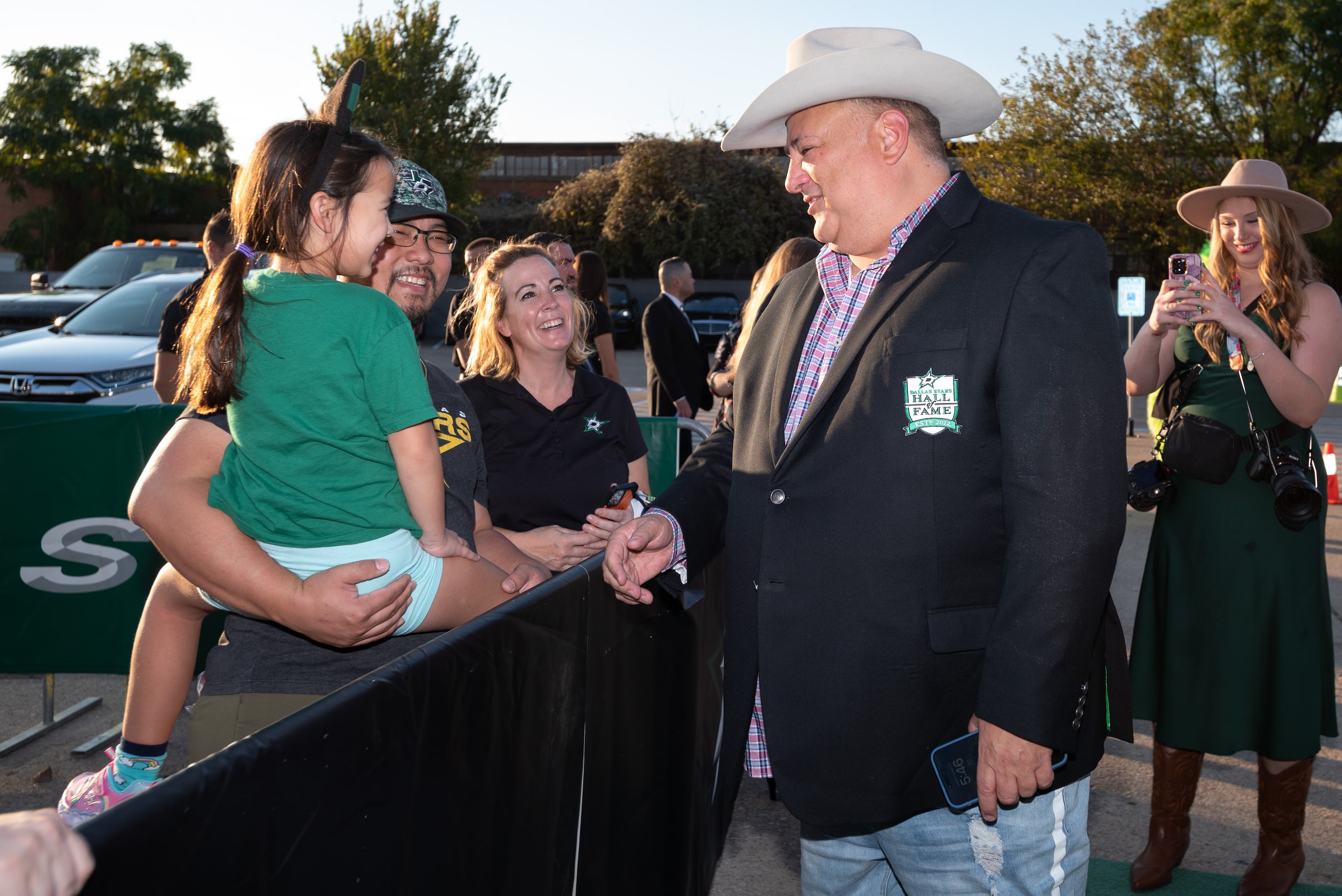 Dallas Stars owner Tom Gaglardi greets fans Rosalyn Dinh, 6, and her father Toan Dinh, as he...