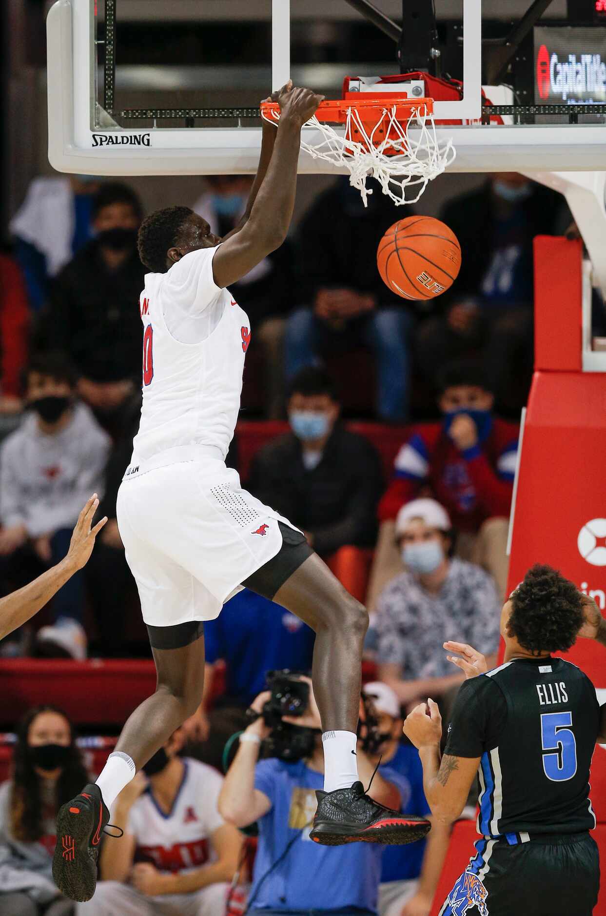 SMU forward Yor Anei (10) dunks as Memphis guard Boogie Ellis (5) looks on during the first...