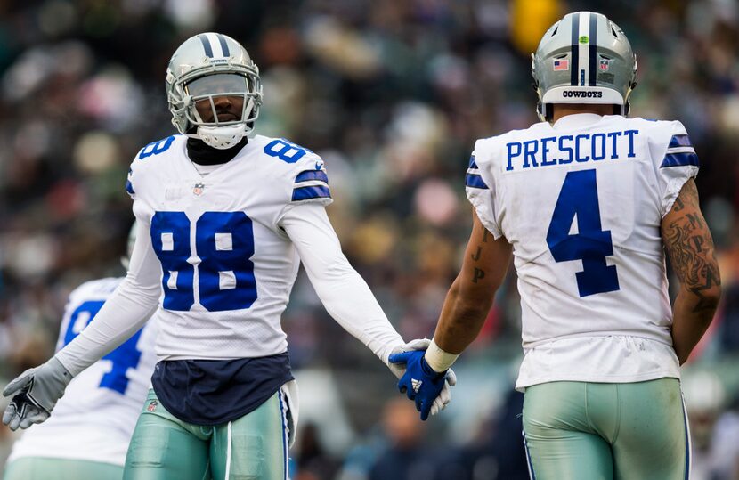 Dallas Cowboys wide receiver Dez Bryant (88) high-fives quarterback Dak Prescott (4) during...