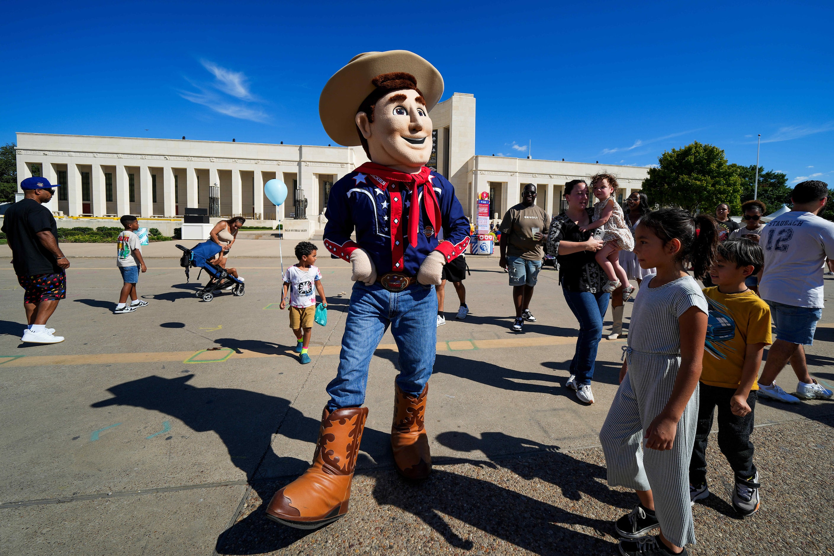 Little Big Tex poses with fairgoers on Lone Star Boulevard at the State Fair of Texas on...