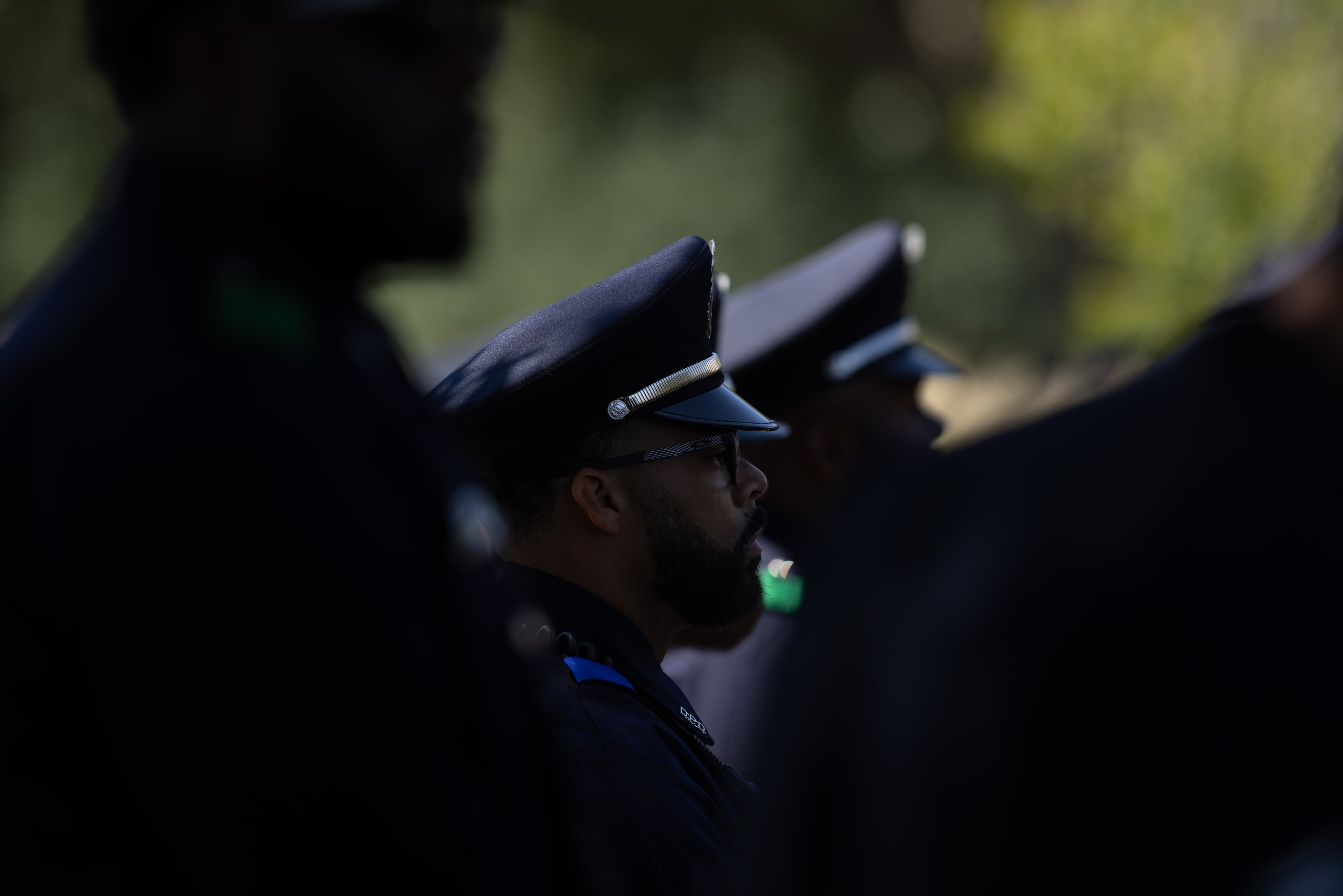 Officers watch the outdoor funeral service of Darron Burks, the 46-year-old Dallas police...