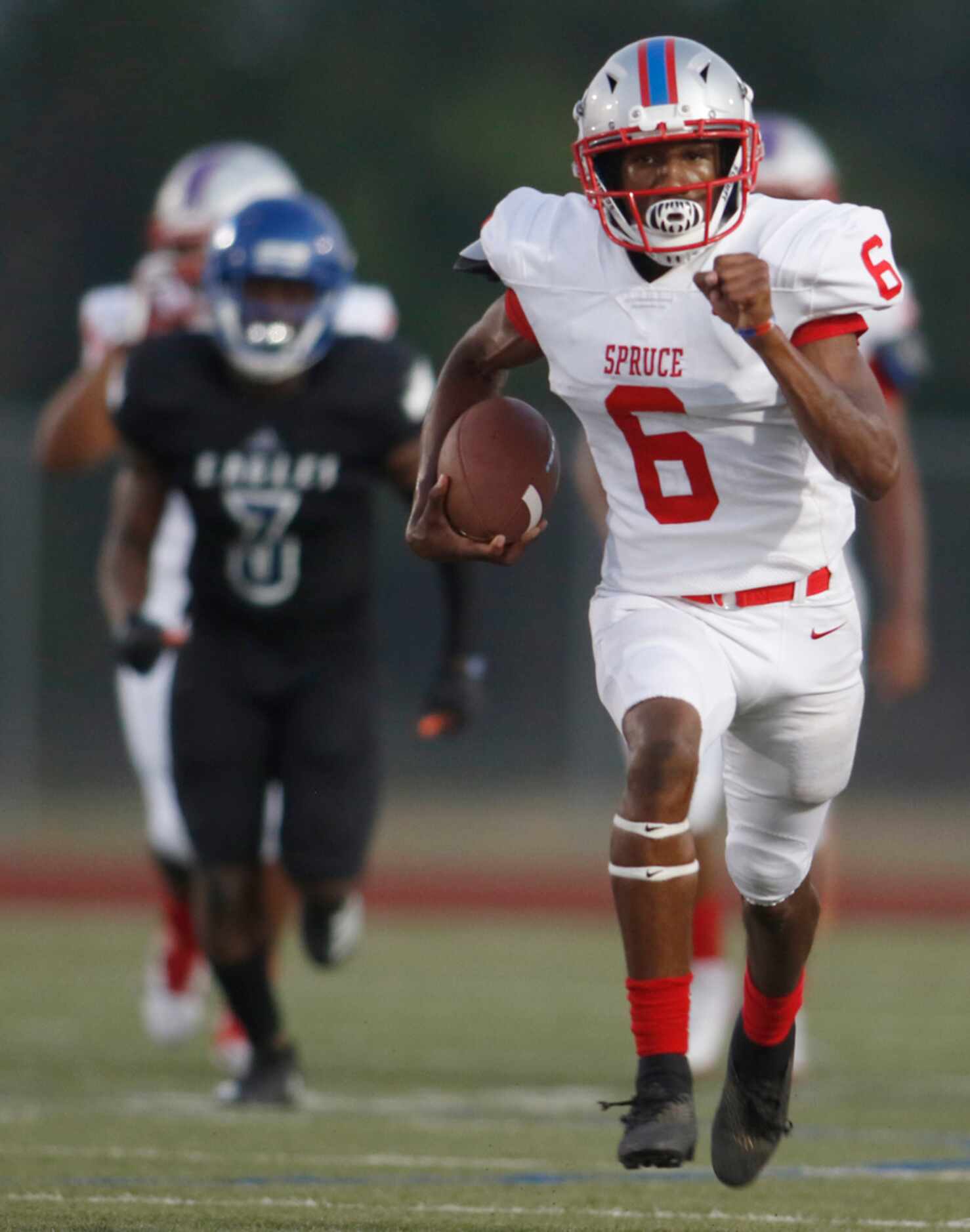 Spruce receiver Adrian Wickware (6) sprints to the end zone enroute to a 64-yard touchdown...