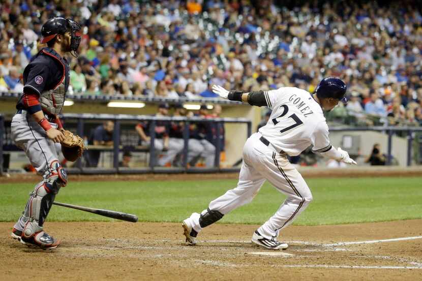 Milwaukee Brewers' Carlos Gomez hits an RBI single during the seventh inning of a baseball...
