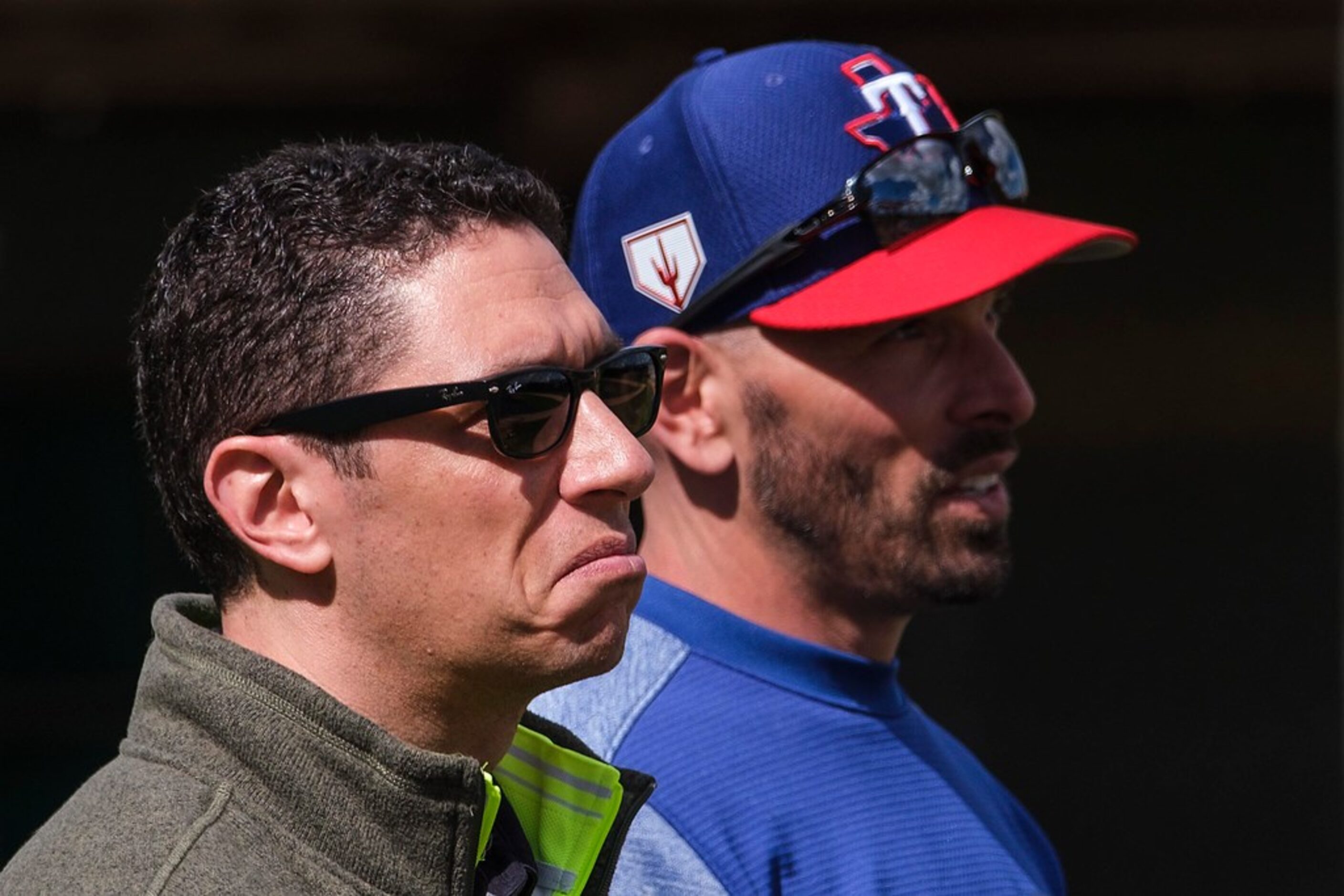 Texas Rangers general manager Jon Daniels  (left) and manager Chris Woodward watch batting...