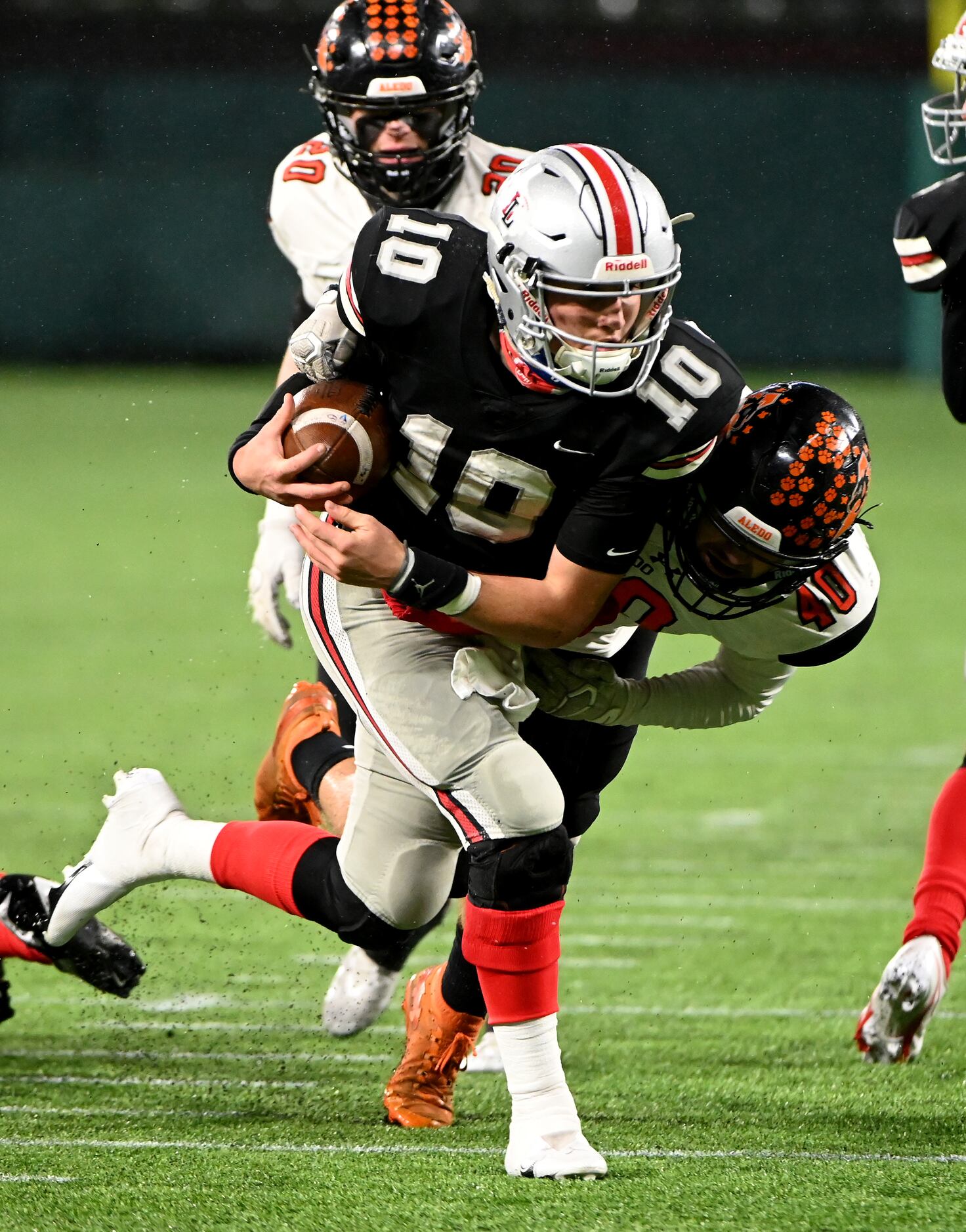 Lovejoy quarterback RW Rucker (10) tries to run through a tackle attempt by Aledo’s Keenan...